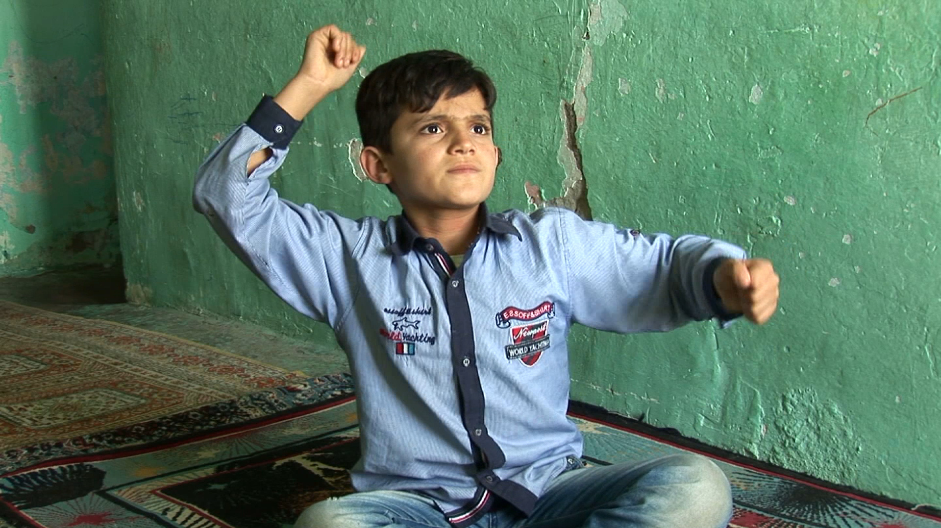Artists Take On Global Migration: 'It's Hard To Watch And It's Hard Not To Watch' 3 A boy describes the bombing of his village in Erkan Özgen's 2016 video Wonderland.