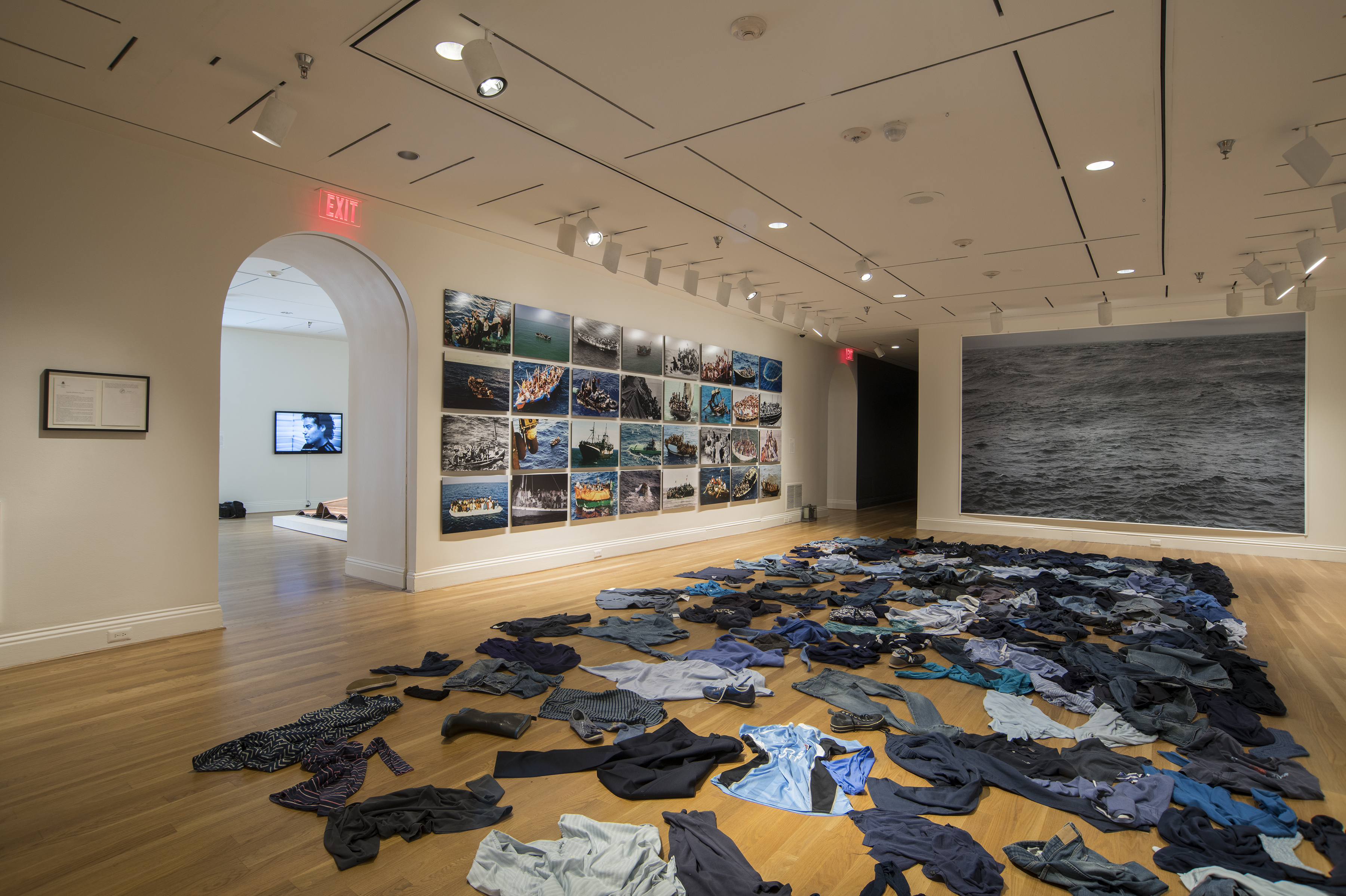 Artists Take On Global Migration: 'It's Hard To Watch And It's Hard Not To Watch' 1 Kader Attia strews second-hand clothing on the floor for the installation La Mer Morte (The Dead Sea).