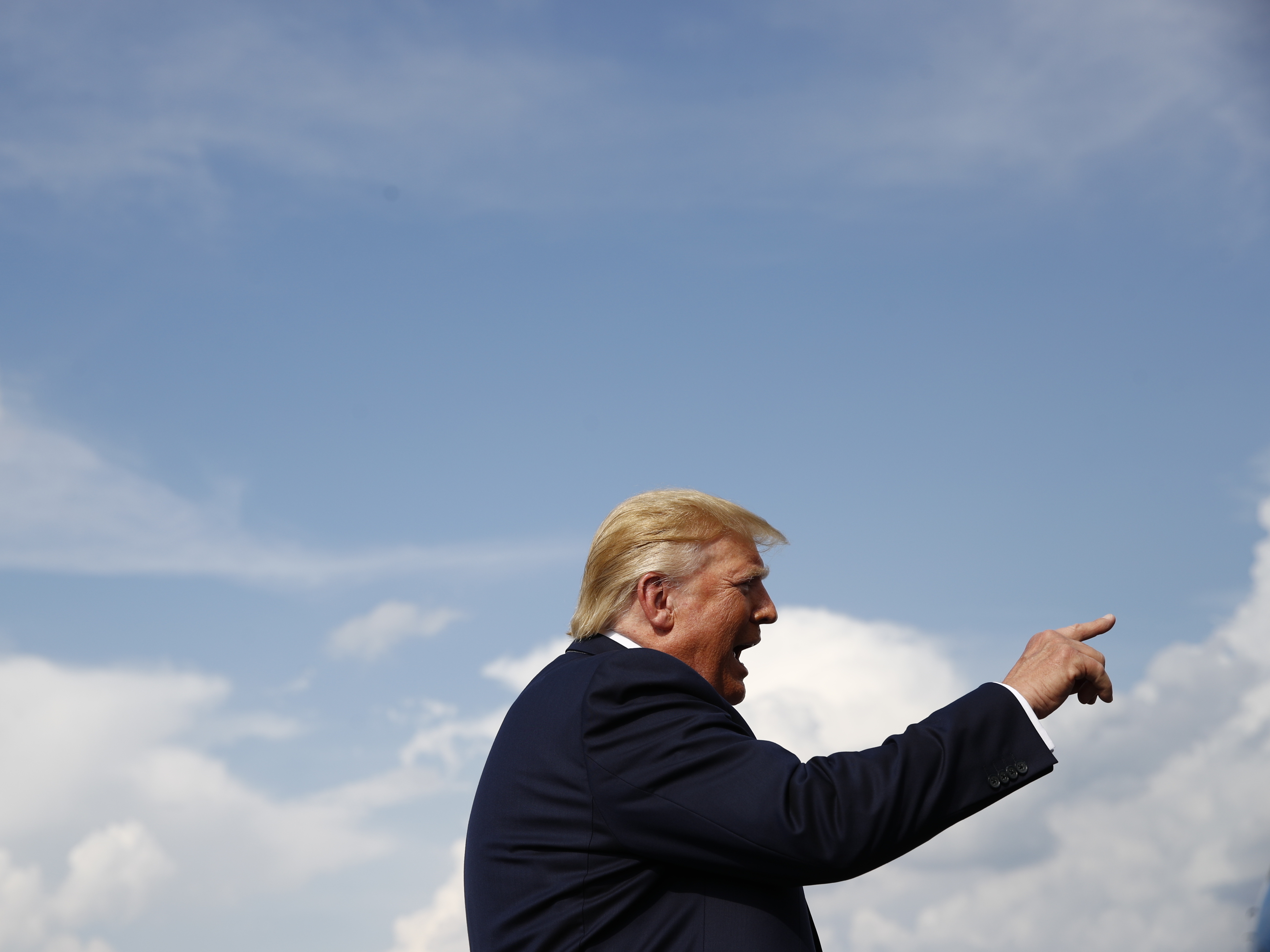 President Donald Trump speaks with reporters before boarding Air Force One at Morristown Municipal Airport in Morristown, N.J., Sunday. Among the topics was Trump's interest in buying Greenland from Denmark.
