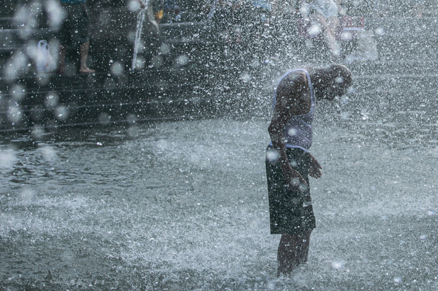 A man cools off in a fountain in New York's Washington Square Park this summer. Death from all causes doubled during a heat wave in New York City in August 1975, with heart attacks and strokes accounting for a majority of the excess deaths. (Jeenah Moon/Bloomberg via Getty Images)