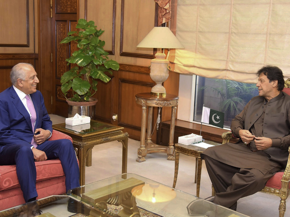 Pakistan's Prime Minister Imran Khan meets U.S. Special Envoy Zalmay Khalilzad (left) in Islamabad on Aug. 1. Khalilzad met Khan ahead of peace talks in Qatar with the Taliban. (Press Information Department via AP)