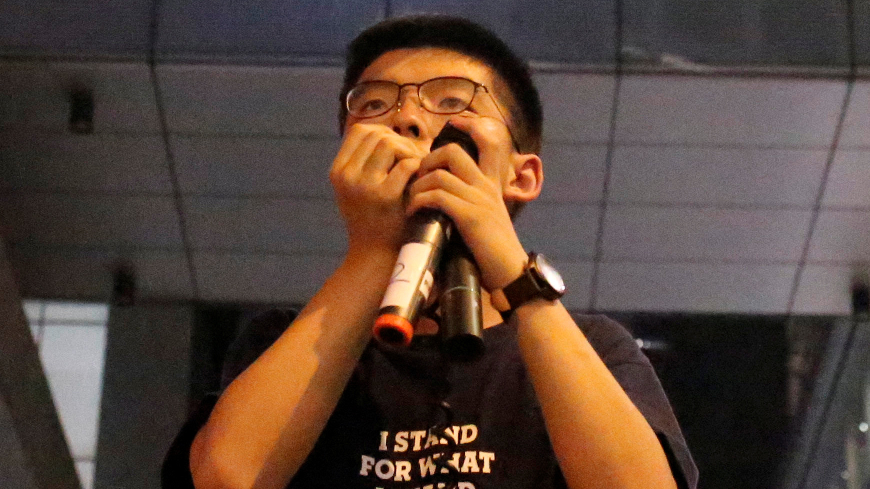 Joshua Wang speaks to protesters outside of police headquarters in Hong Kong on June 21.