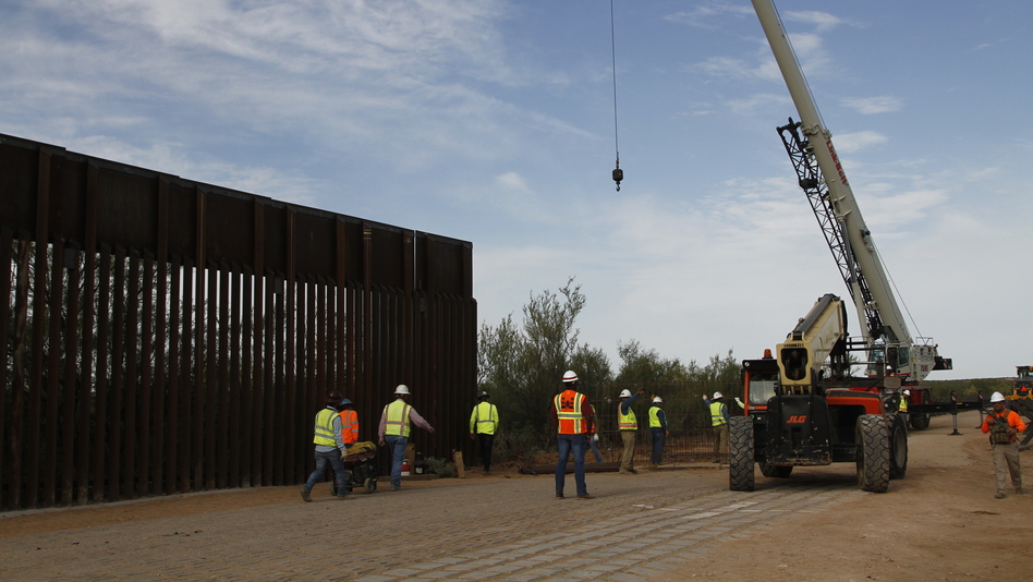Workers break ground on new border wall construction about 20 miles west of Santa Teresa, N.M., last month. The Trump administration has started the arduous process of canceling $3.6 billion in military construction projects to fund its plans to build more of a wall along the U.S.-Mexico border. (Cedar Attanasio/AP)