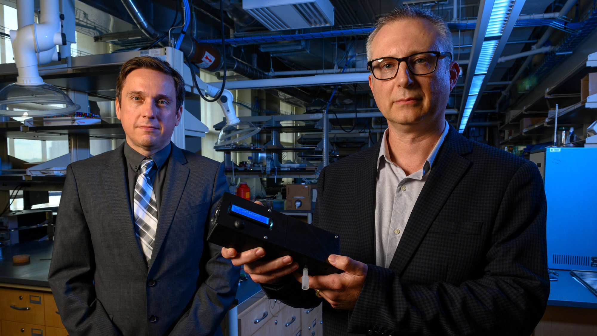 University of Pittsburgh researchers Ervin Sejdic and Alexander Star hold up their prototype Breathalyzer-style device for detecting THC — the main psychoactive ingredient in marijuana — in a person's breath. (Courtesy of the University of Pittsburgh)