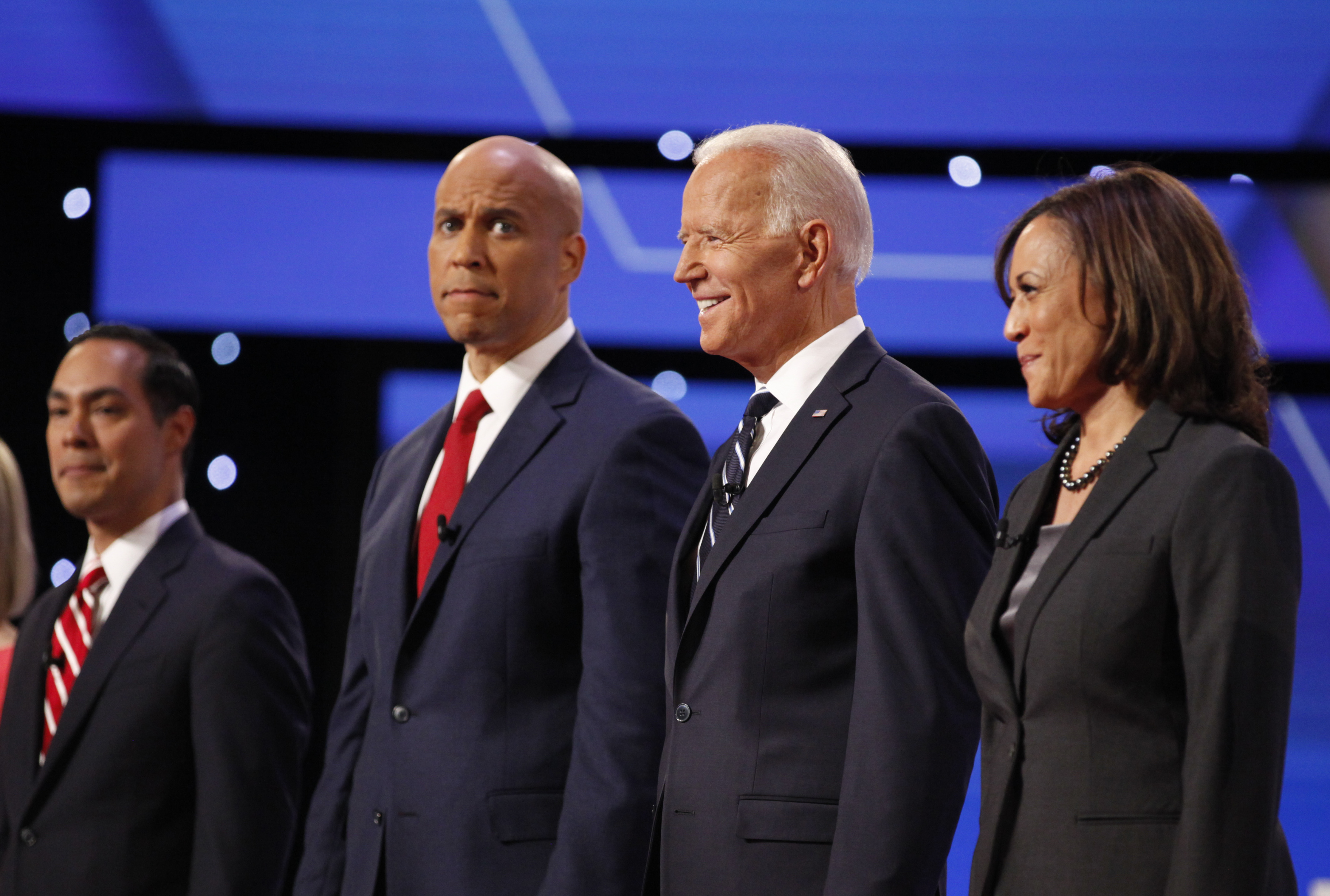 Sen. Cory Booker (left), former Vice President Joe Biden and Sen. Kamala Harris stand with 10 of the Democratic candidates for president Wednesday, July 30, 2019, on the second night of the second Democratic presidential debates.