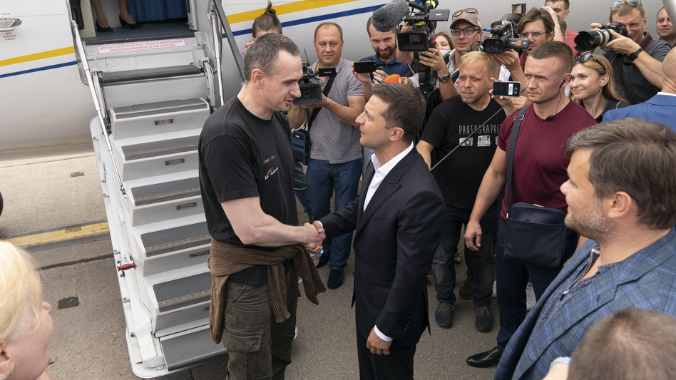 Ukraine's President Volodymyr Zelensky, right, greets Ukrainian prisoner filmmaker Oleg Sentsov upon his arrival in Ukraine, Saturday, Sept. 7, 2019. (Efrem Lukatsky/AP)