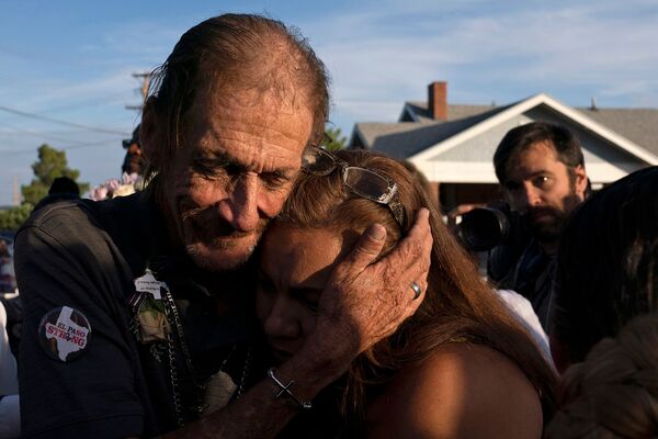 Antonio Basco, husband of El Paso Walmart shooting victim Margie Reckard, hugs an attendee during his wife's visitation service in El Paso, Texas, in August.