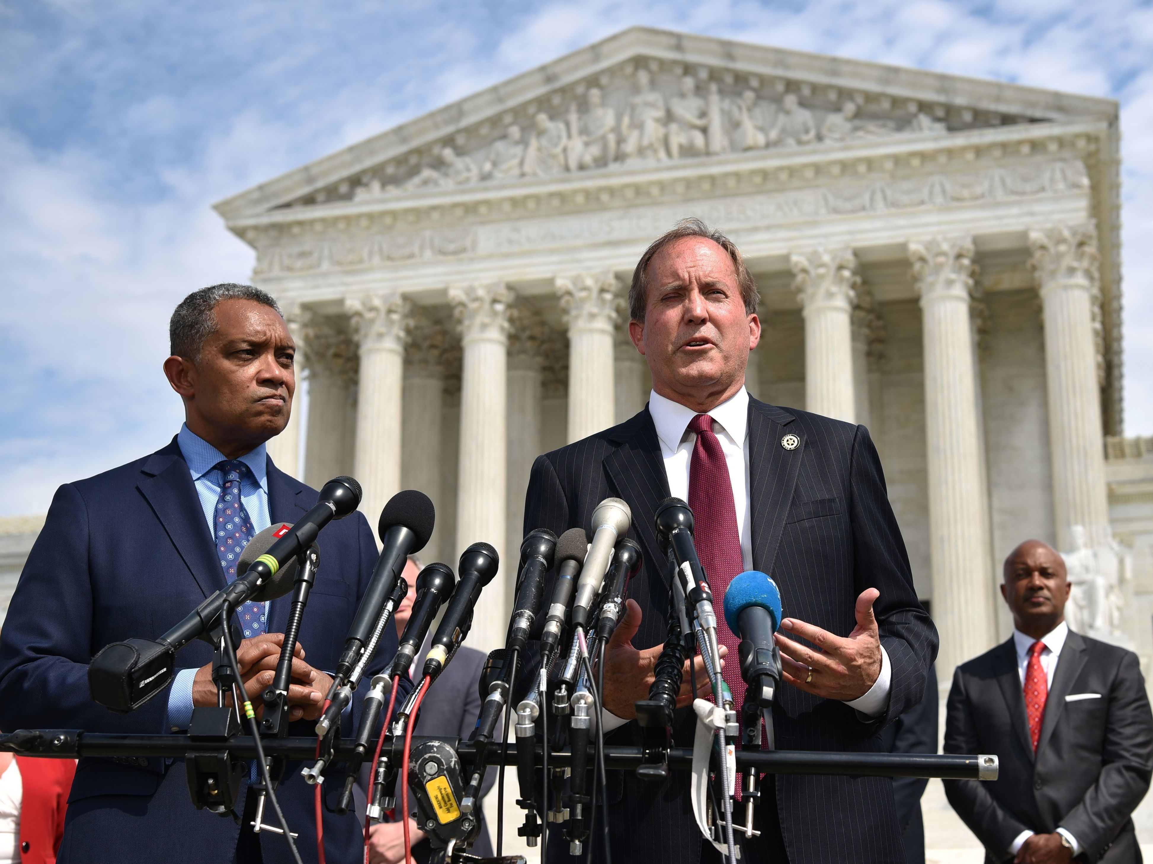 District of Columbia Attorney General Karl Racine (left) and Texas Attorney General Ken Paxton speak Monday about the launch of an antitrust investigation into Google outside the Supreme Court in Washington, D.C. (AFP/Getty Images)