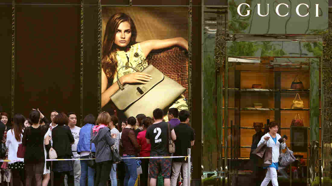 SHANGHAI, CHINA - Customers wait outside Gucci Store in Golden Eagle Shopping Center in Shanghai, China.