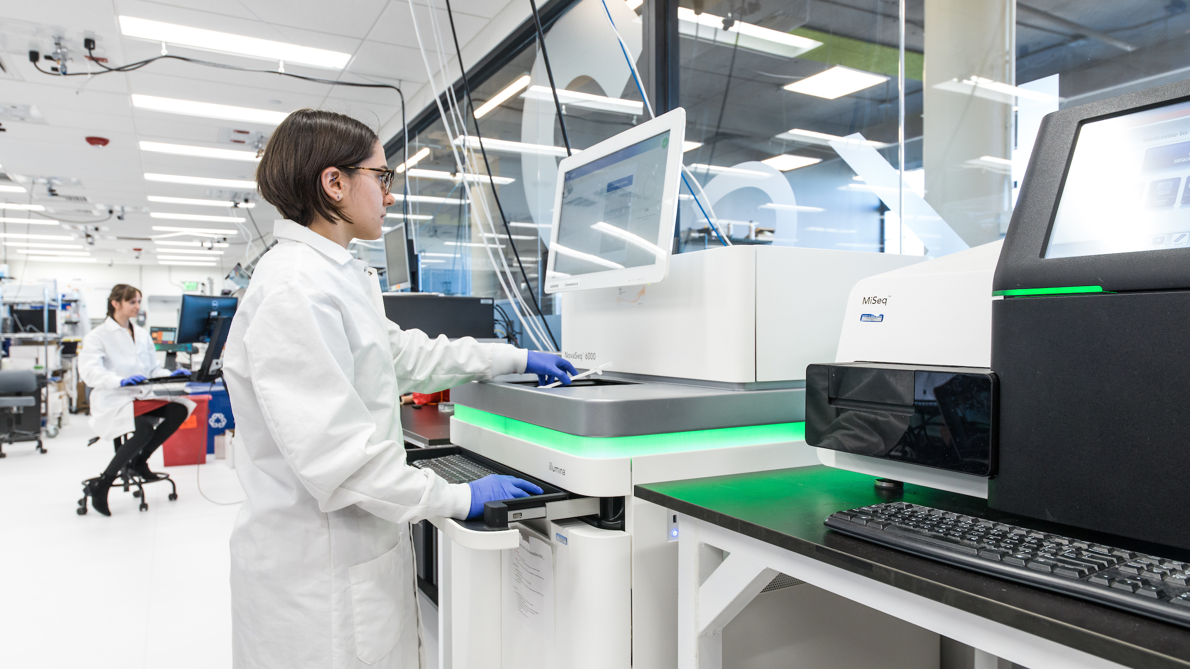 An employee of the Boston biotech company Ginkgo Bioworks runs a gene sequencing machine through its paces. The company synthesizes thousands of genes a month, which are then inserted into cells that become mini factories of useful products.