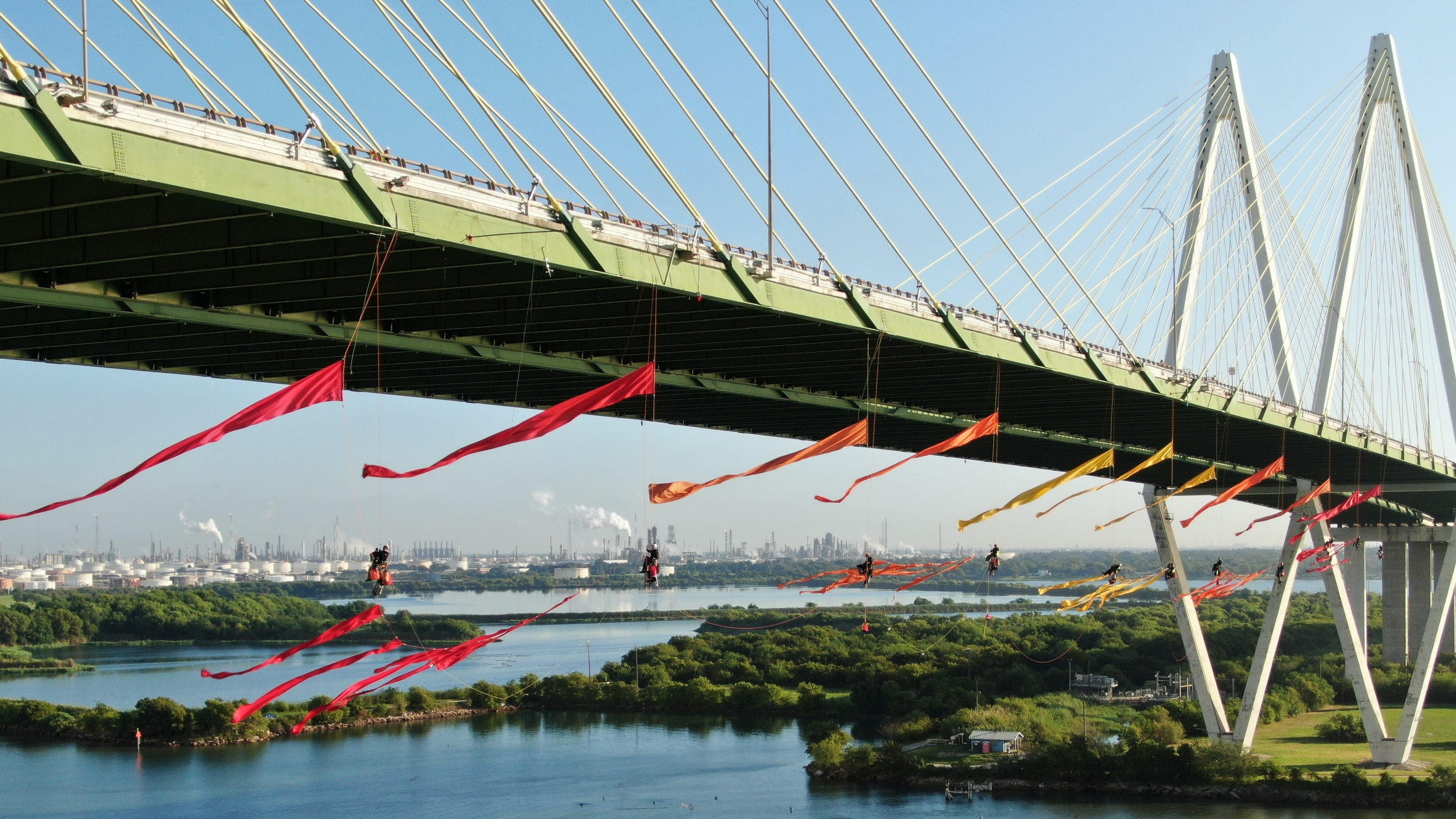 Greenpeace USA climbers rappelled off and formed a blockade on the Fred Hartman Bridge near Baytown, Texas, shutting down the Houston Ship Channel, the largest fossil fuel thoroughfare in the United States.