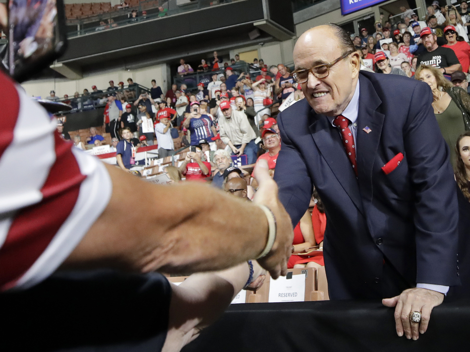 Former New York City Mayor Rudy Giuliani shook hands with supporters as he arrived at President Trump's campaign rally on Aug. 15 in Manchester, N.H. (Elise Amendola/AP)