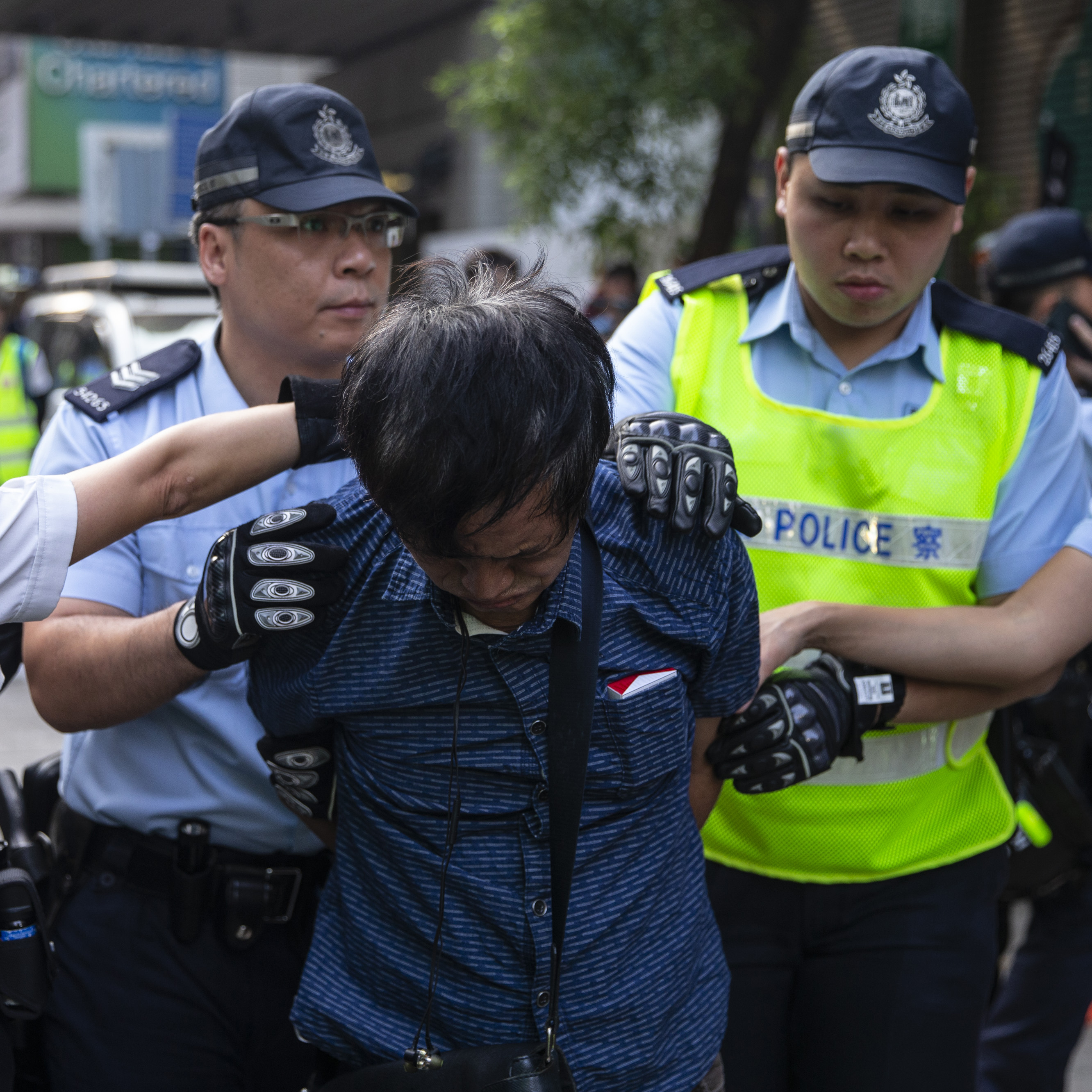 Police officers detain a pro-government supporter during clashes with demonstrators in the Wan Chai district of Hong Kong on Tuesday.