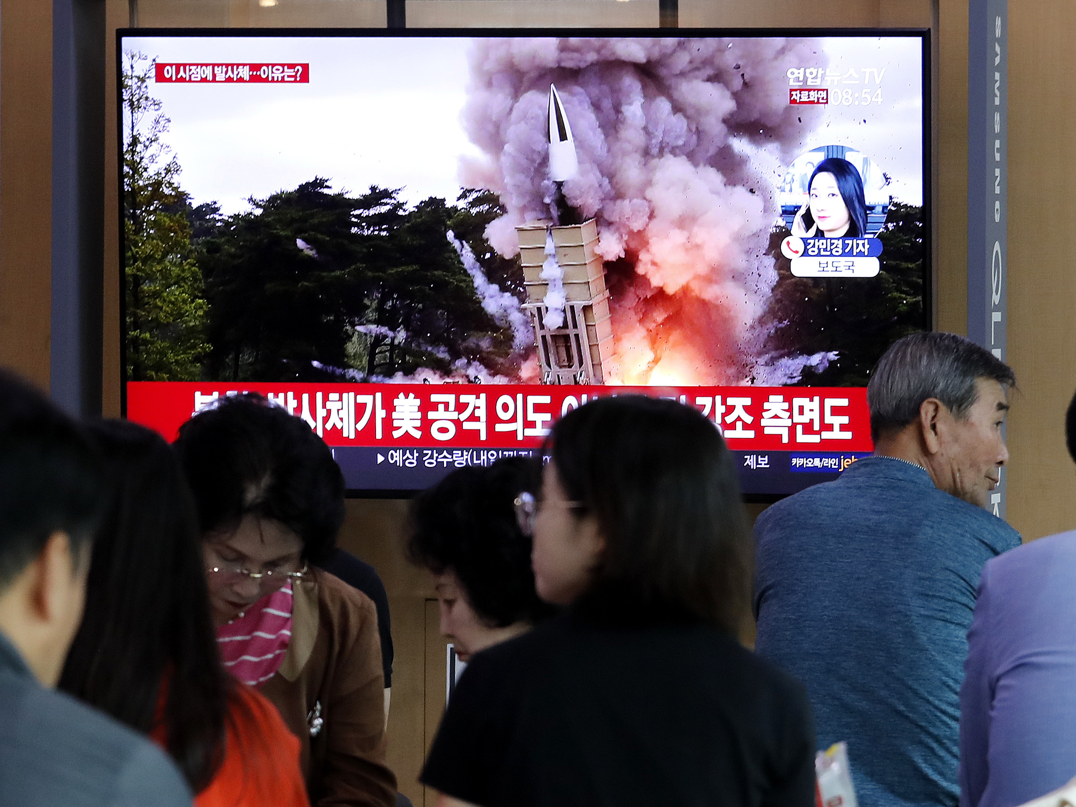 People at the Seoul Railway Station watch a newscast showing a file image of a North Korean missile launch. North Korea on Wednesday fired projectiles toward its eastern sea, South Korea's military said, in an apparent display of its expanding military capabilities ahead of planned nuclear negotiations with the United States this weekend.