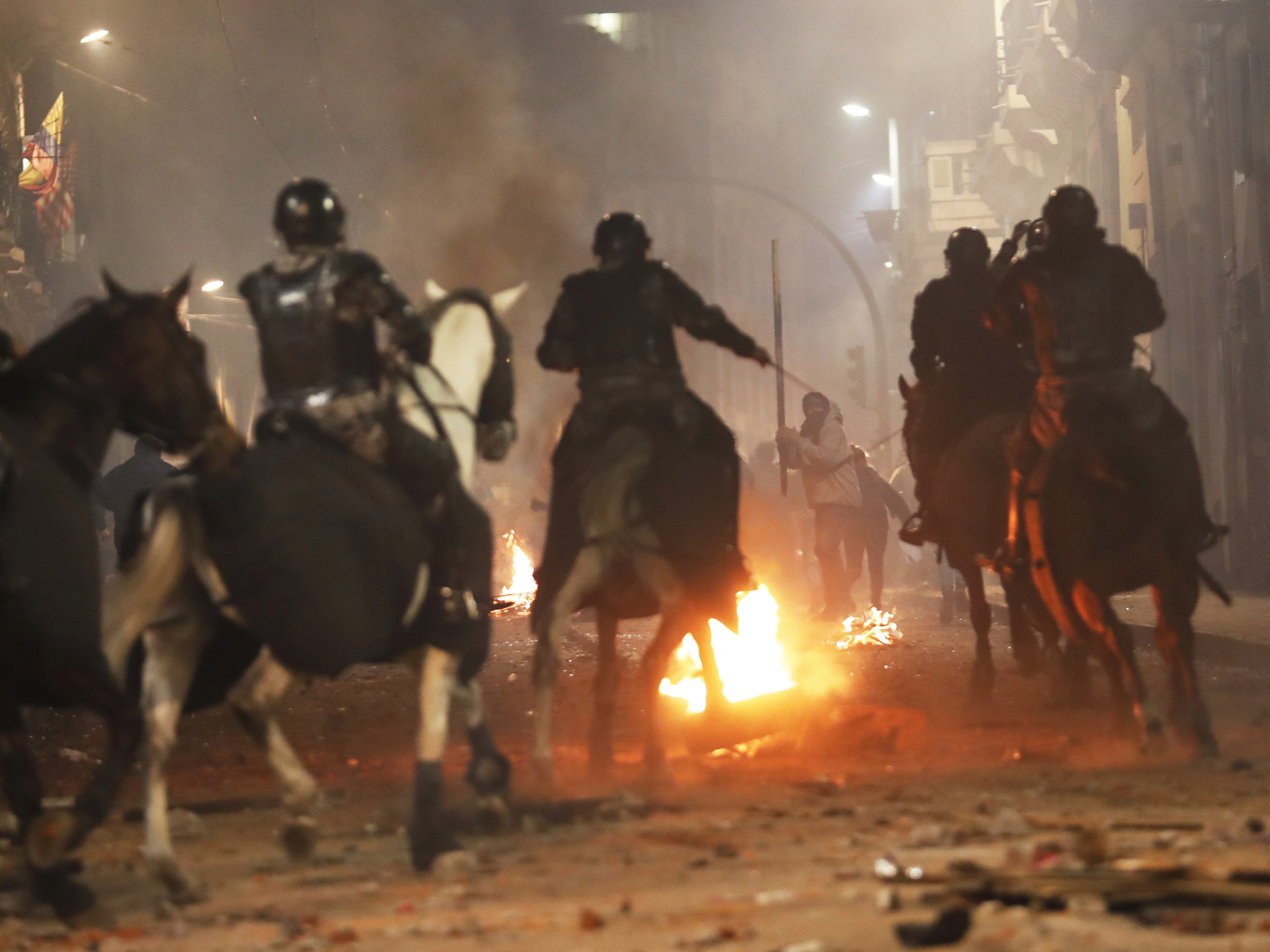 Mounted police in Quito advance on demonstrators protesting Ecuadorian President Lenín Moreno's move to scrap fuel subsidies, in a clash near the government palace late Thursday.