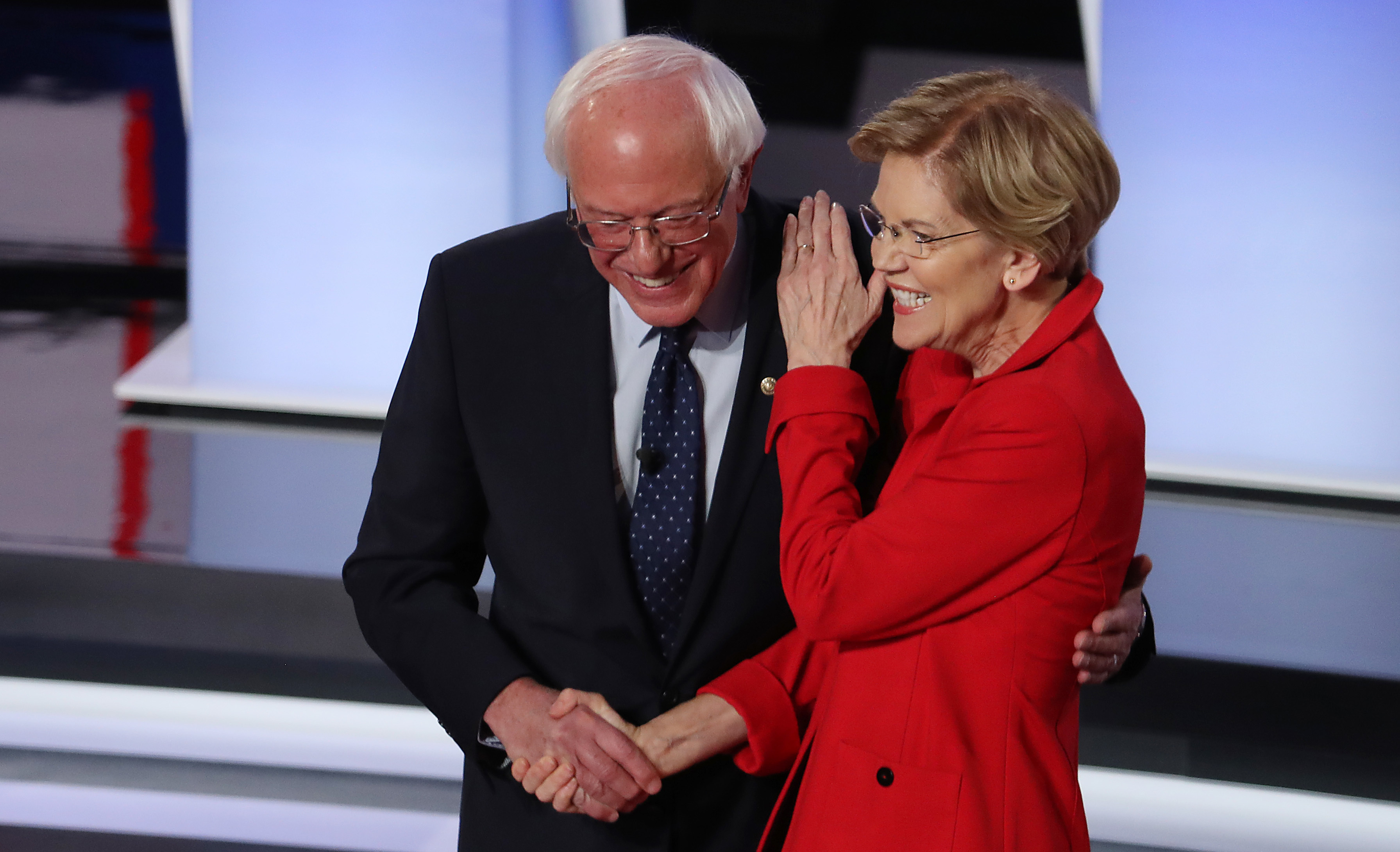 Sens. Bernie Sanders of Vermont and Elizabeth Warren of Massachusetts greet each other at the start of the Democratic presidential debate in Detroit in July. (Getty Images)