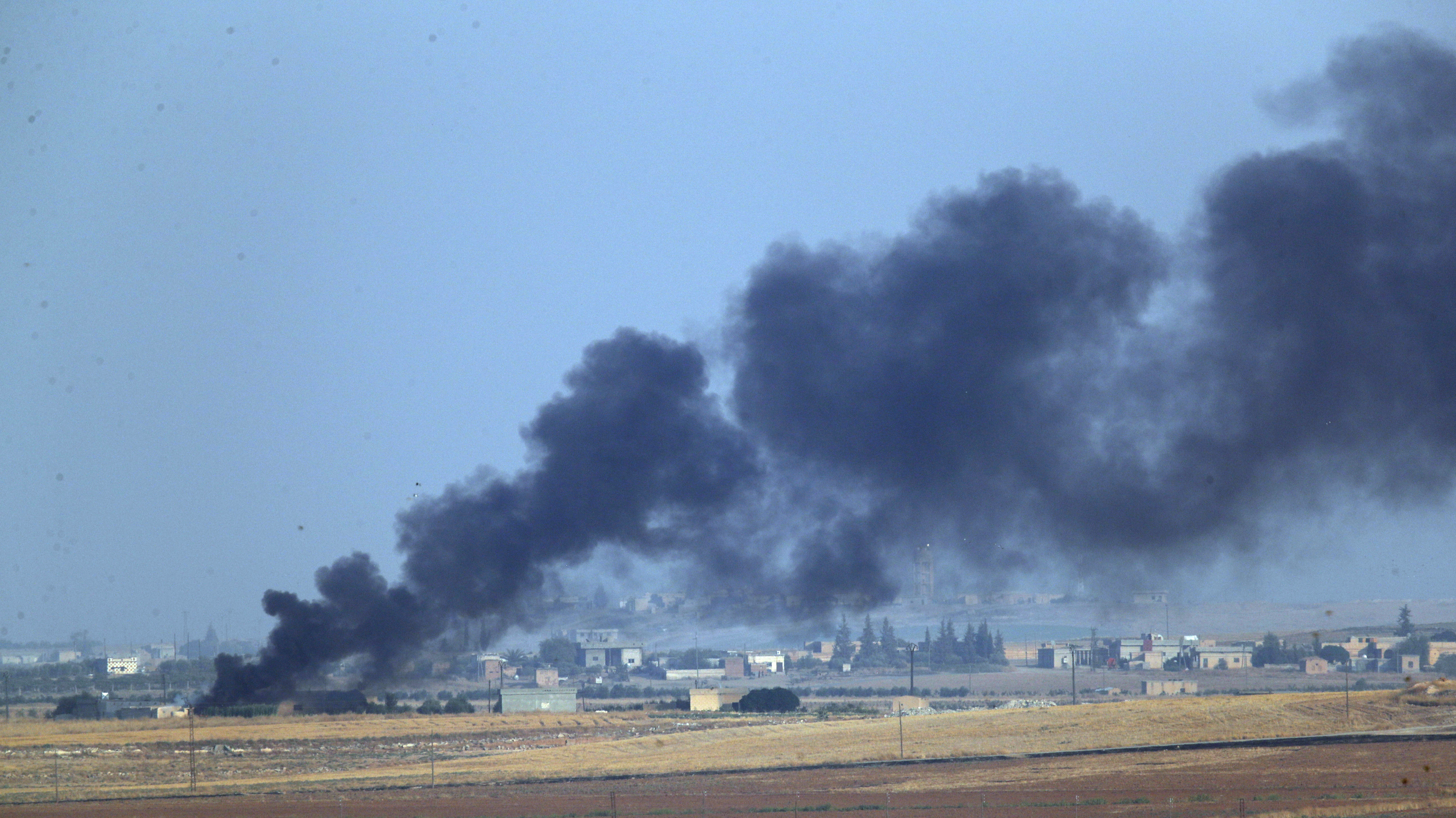 In this photo taken from the Turkish side of the border between Turkey and Syria, in Akcakale, Sanliurfa province, southeastern Turkey, smoke billows from a fire inside Syria during bombardment by Turkish forces on Wednesday.