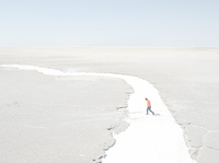 Iran's Lake Urmia has shriveled because of water mismanagement. Photographer Maximilian Mann traveled to northwest Iran to document life in the region. Here, a man walks in what used to be a river to the lake, now just salt.