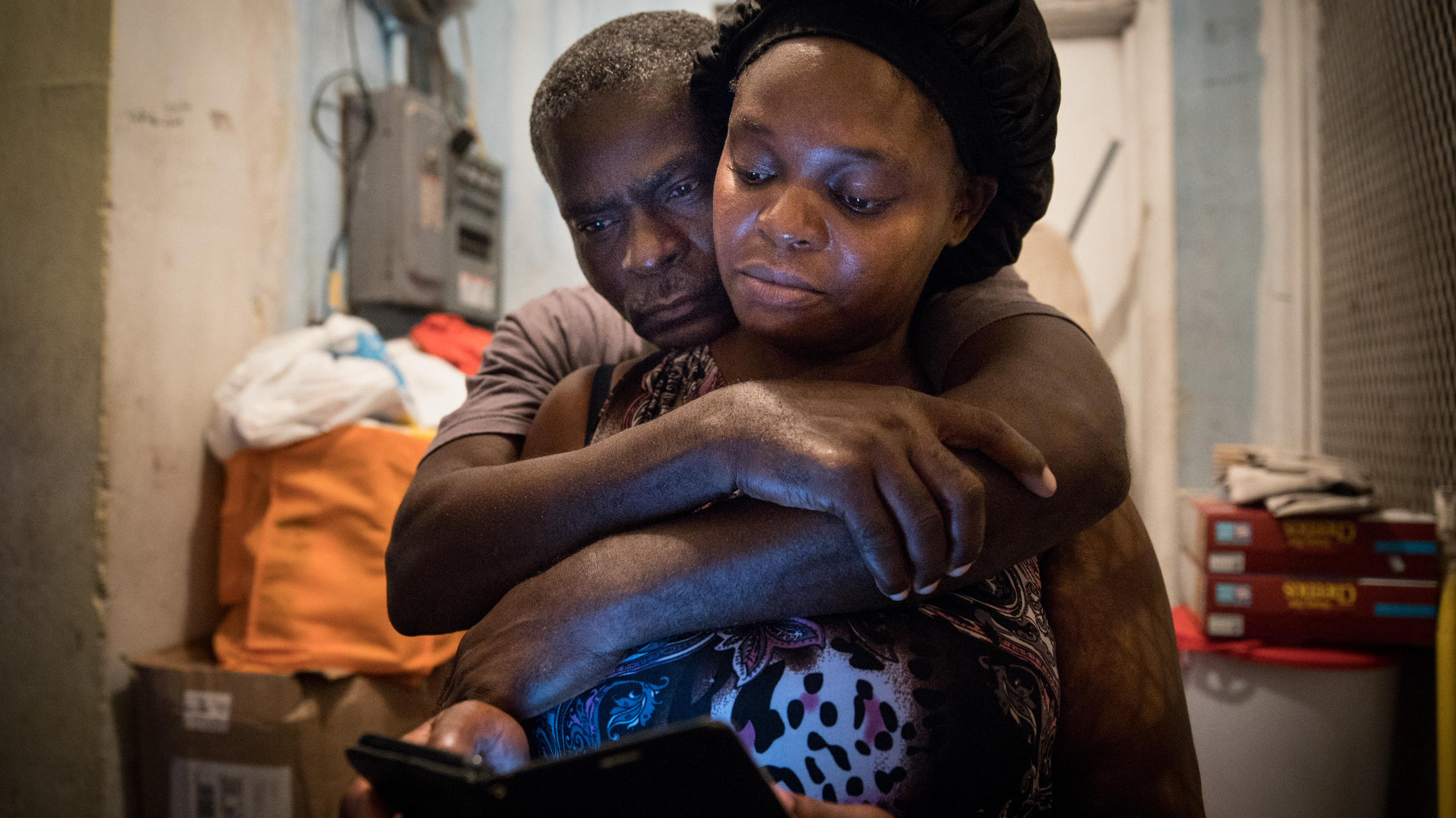 A month after Hurricane Dorian devastated the Bahamas, Sherrine Petit Homme LaFrance gets a hug from husband Ferrier Petit Homme. The storm destroyed their home on Grand Abaco Island. They are now living with China Laguerre in Nassau.