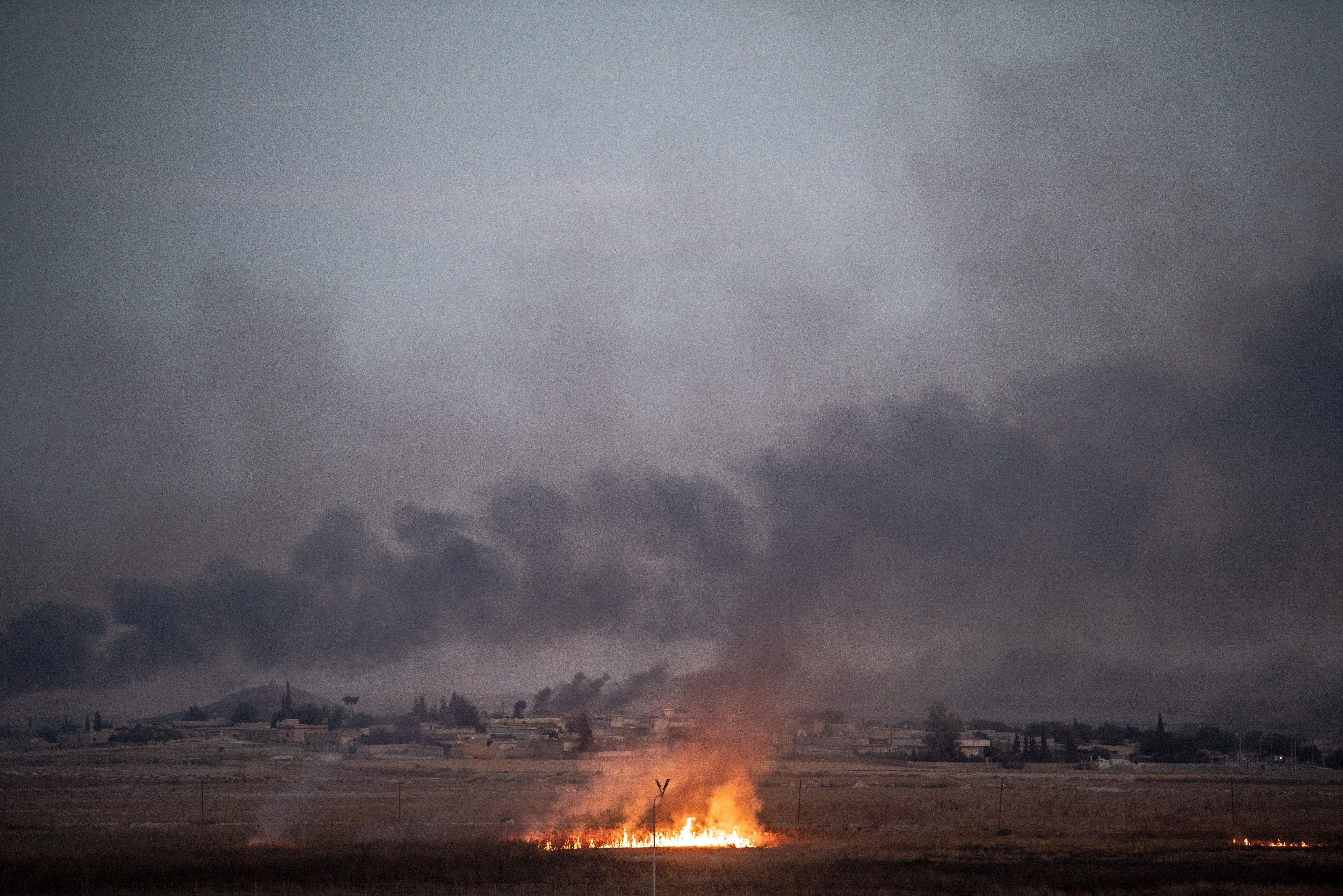 Smoke rises from the Syrian town of Tal Abyad, where a hospital was shuttered because of the fighting. (AFP via Getty Images)