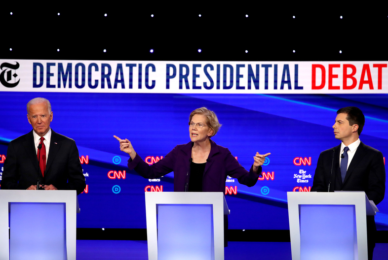 Left to right: former Vice President Joe Biden, Massuchusetts Sen. Elizabeth Warren and South Bend, Ind., Mayor Pete Buttigieg react on stage during the Democratic presidential debate at Otterbein University. (Win McNamee/Getty Images)