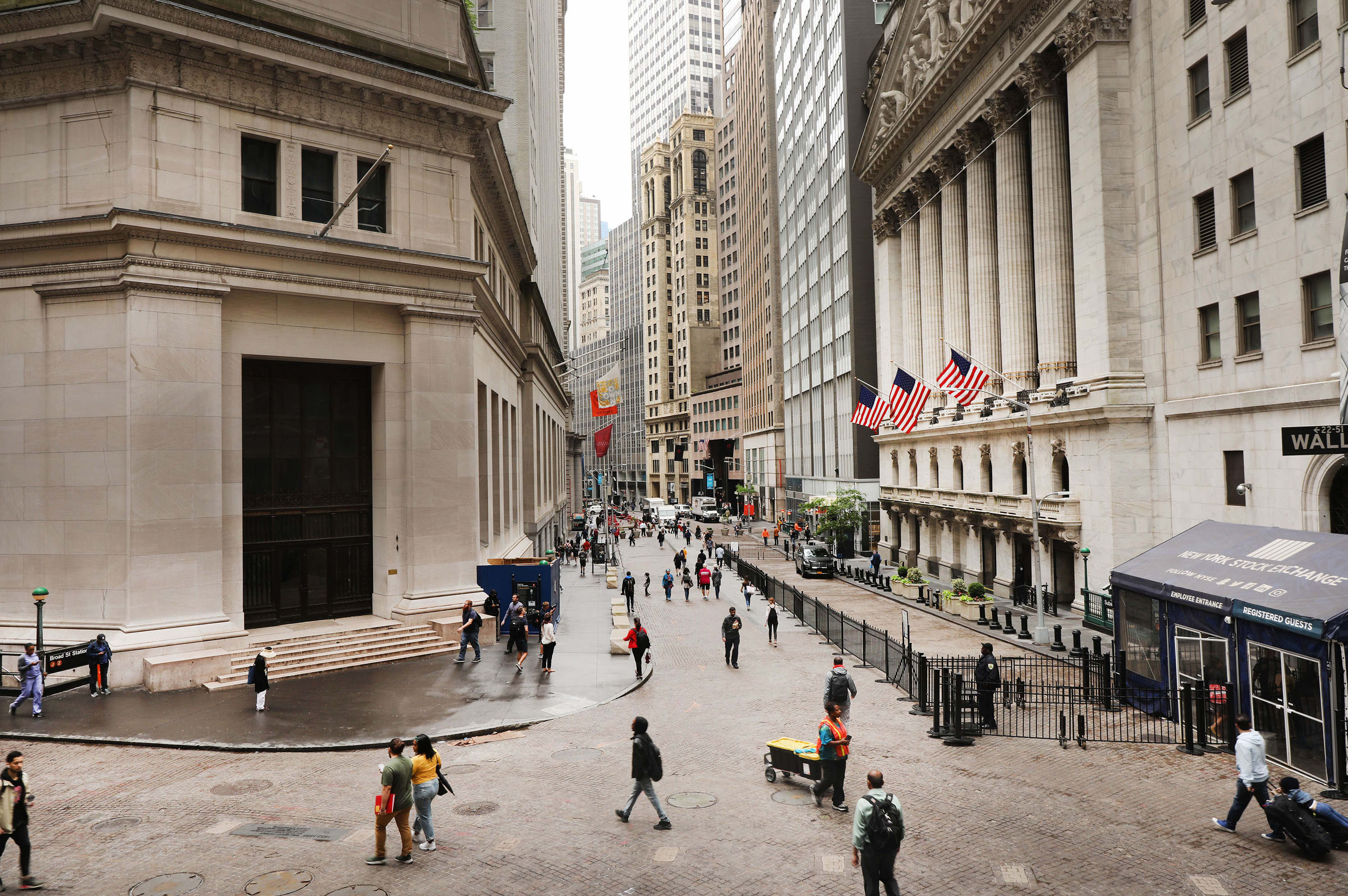 Investors are spending billions of dollars to align their portfolios with their personal values. But there's little agreement on what exactly qualifies — or disqualifies — an investment option from being marketed as sustainable. Above, pedestrians walk past the New York Stock Exchange on June 10. (Getty Images)