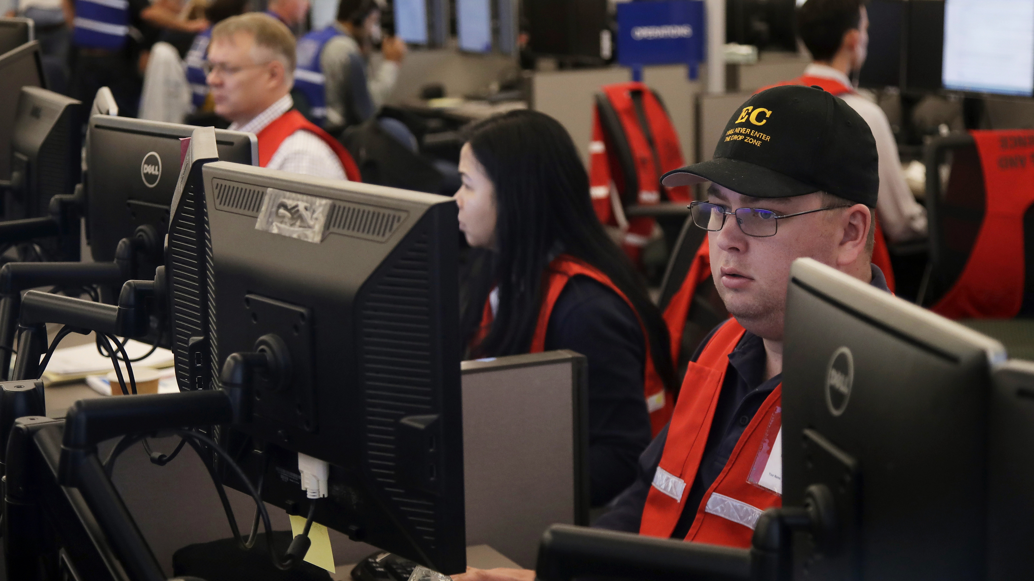 Pacific Gas & Electric employees work in the PG&E Emergency Operations Center in San Francisco. Authorities say power outages have started again in parts of Northern California.