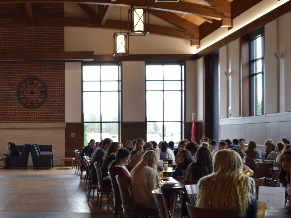 High school students at lunch in the University School of Milwaukee's cafeteria. Students are assigned seats, along with staff, to foster a positive school culture. (Emily Files/WUWM)