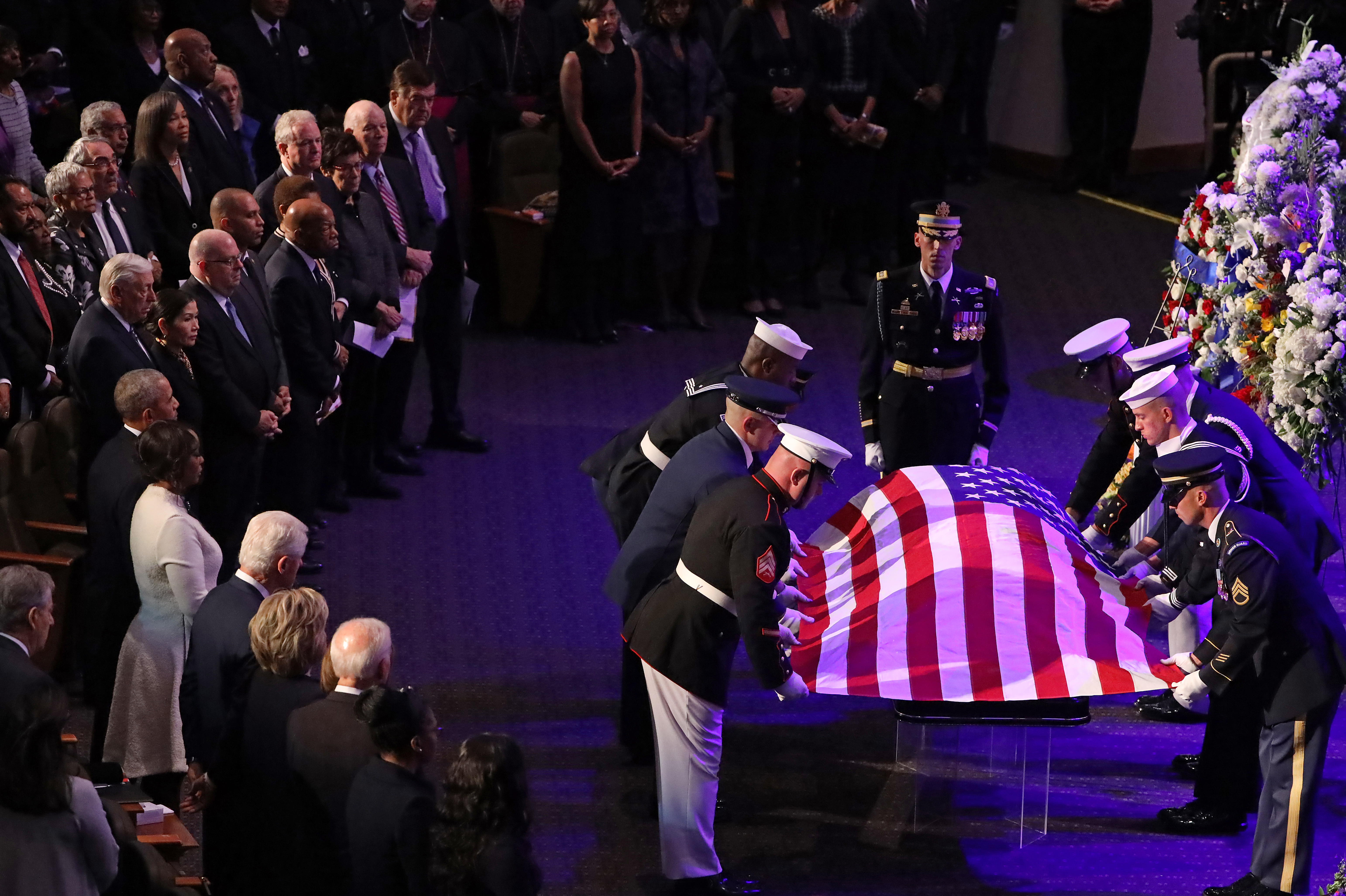 A military honor guard lays the U.S. flag on the casket of Rep. Elijah Cummings during his funeral service at New Psalmist Baptist Church in Baltimore on Friday.