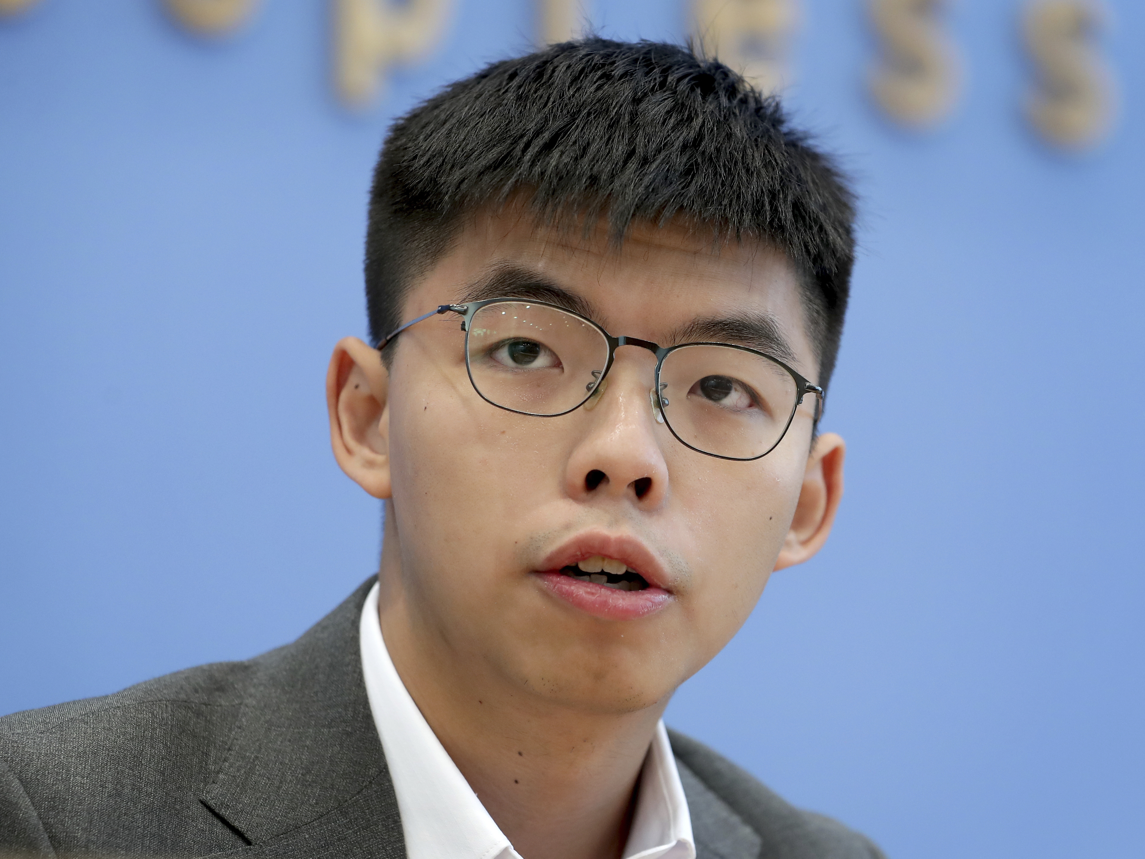Hong Kong activist Joshua Wong addresses the media during a news conference in Berlin, Germany, last month. Wong on Tuesday said Hong Kong authorities have disqualified him from upcoming local council elections.
