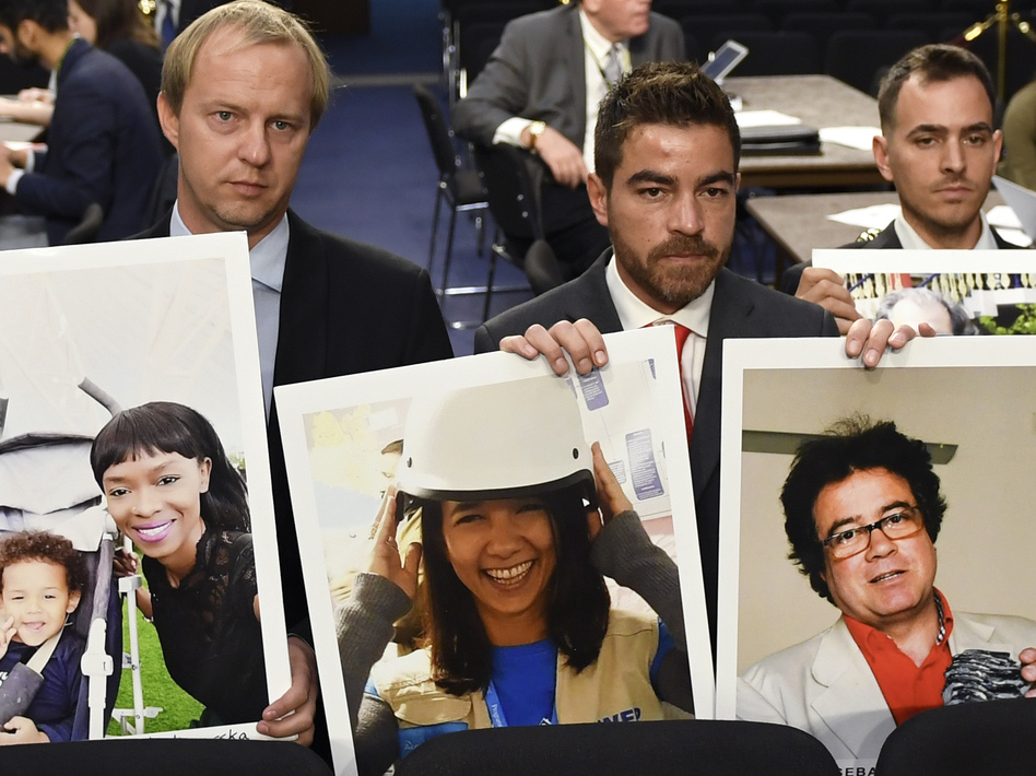 Family members hold photos of victims killed on Ethiopian Airlines Flight 302 and Lion Air Flight 610 on Tuesday. (Susan Walsh/AP)