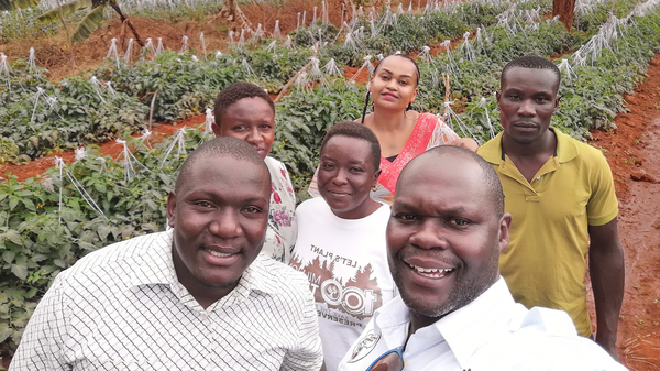 Noah Nasiali-Kadima, foreground, takes a selfie with members of the Africa Farmers Group during a tour of a member