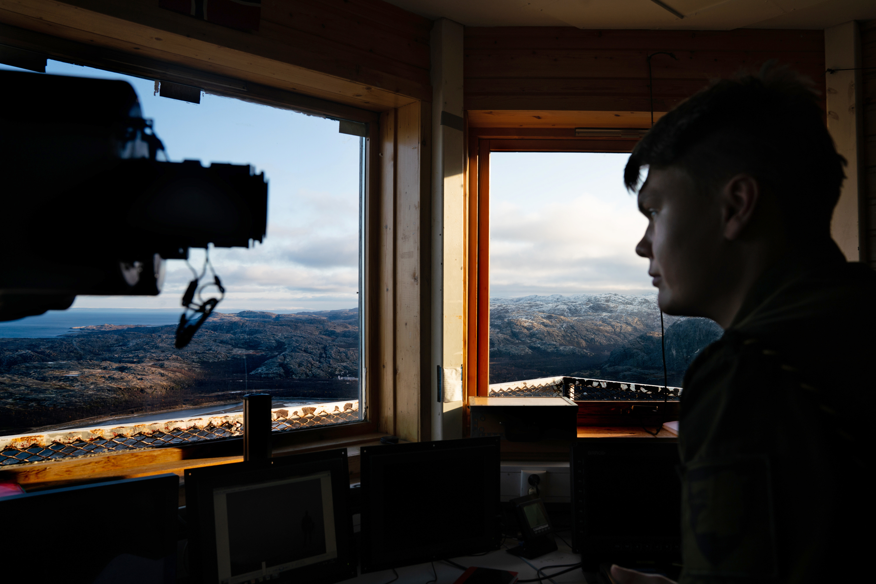 Norwegian Pvt. Ivan Sjoetun sits in the border post where Russian land can be seen out the window. The post is in the far northeast corner of Norway and offers a commanding view of this starkly beautiful area some 250 miles above the Arctic Circle. (NPR)