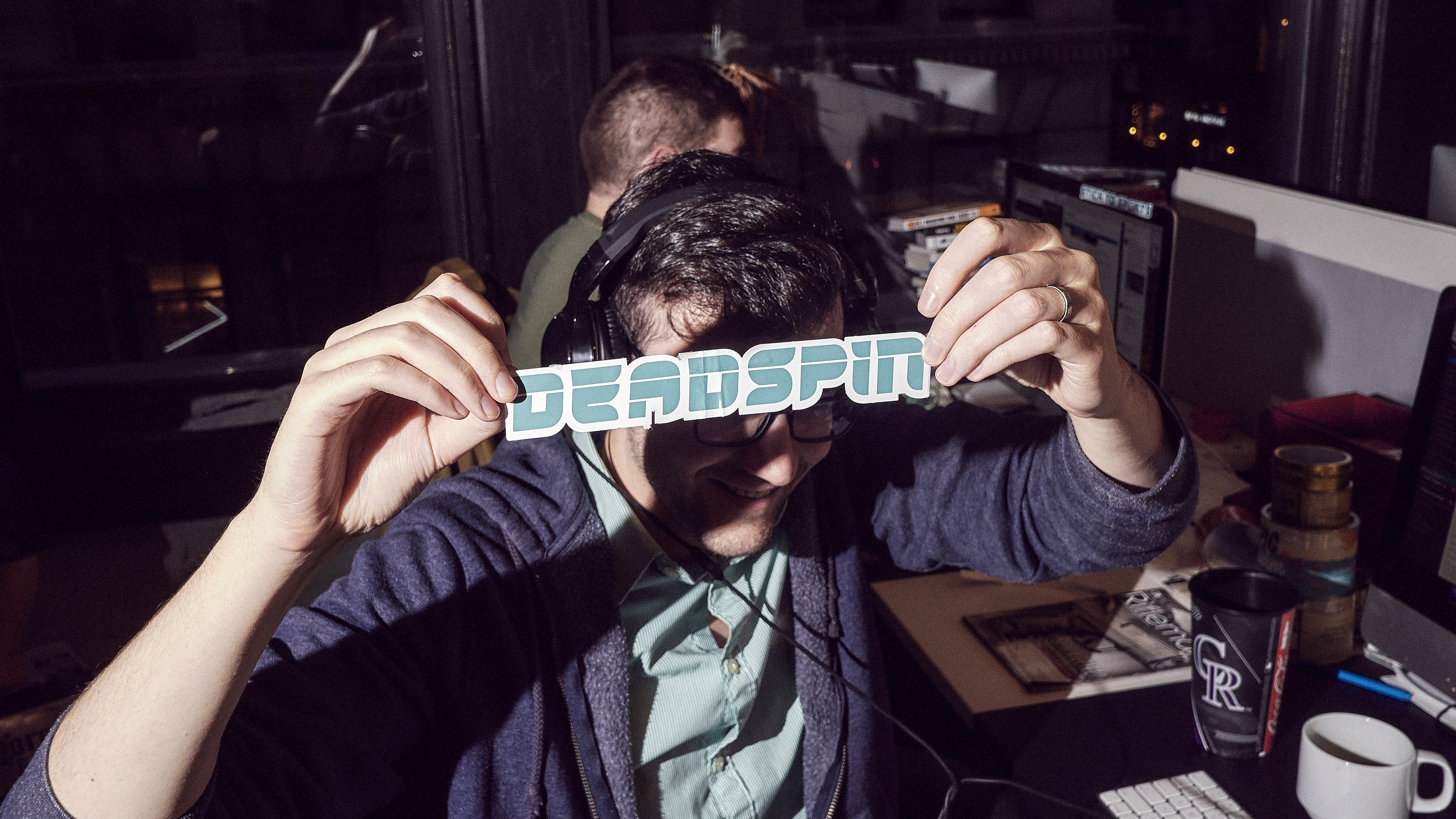 An employee of the website Deadspin shows a logo at their office in Manhattan.