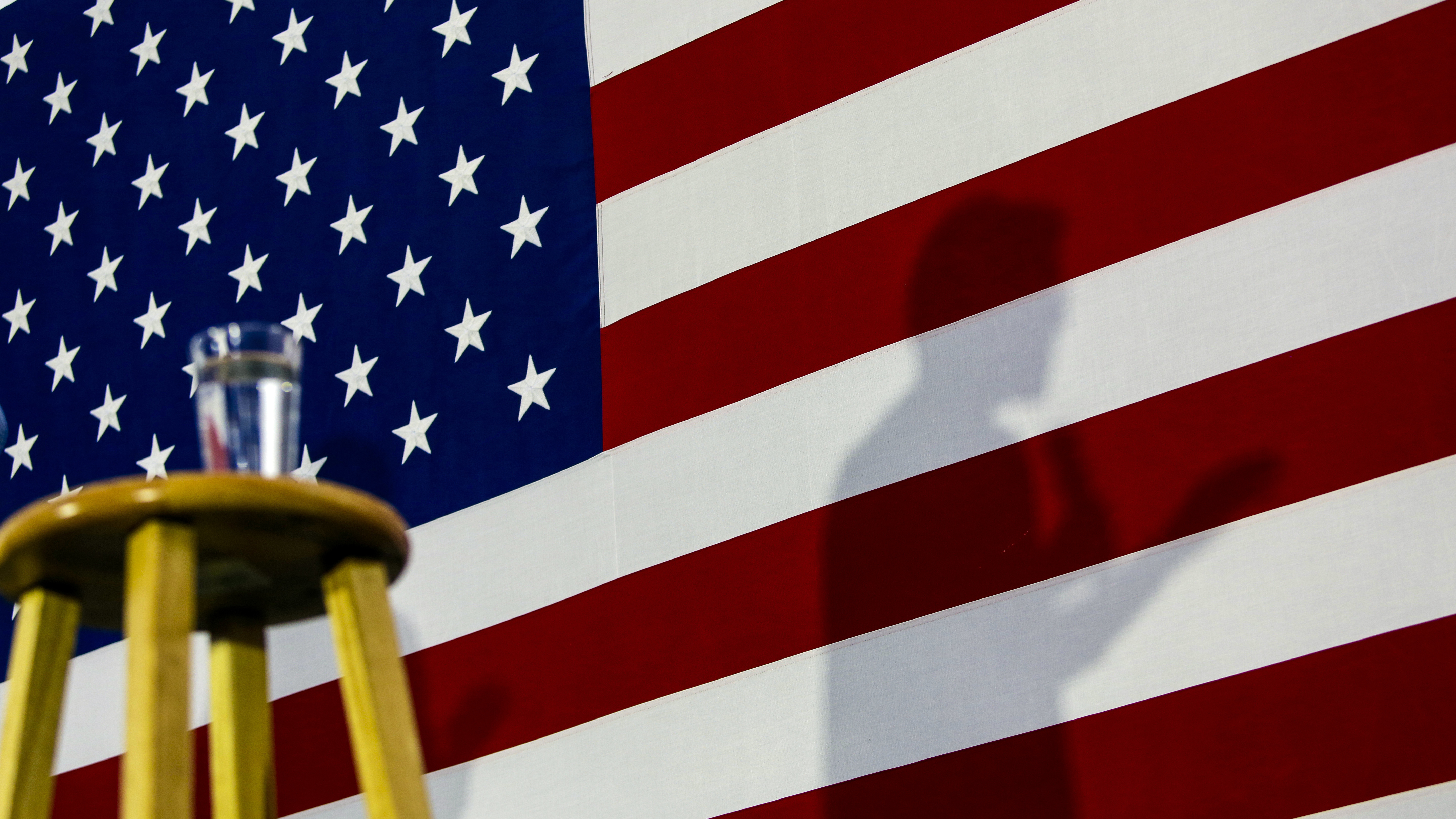 An impeachment trial early next year could keep Sen. Elizabeth Warren, silhouetted during a town hall in Iowa, and other Democratic presidential candidates off the trail at a crucial time. (Getty Images)