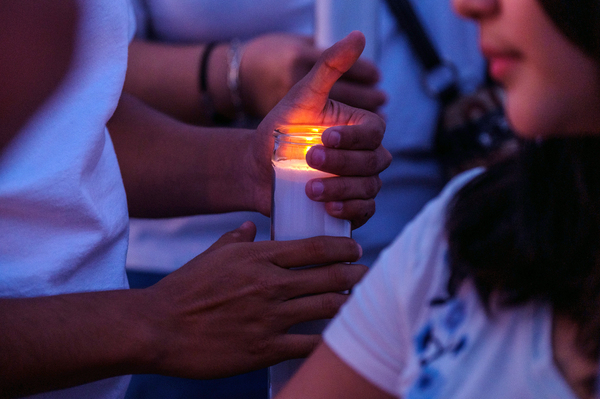 Mourners hold candles as they gather for a vigil at a memorial outside Cielo Vista Walmart in El Paso, Texas, U.S., on Wednesday, Aug. 7, 2019.