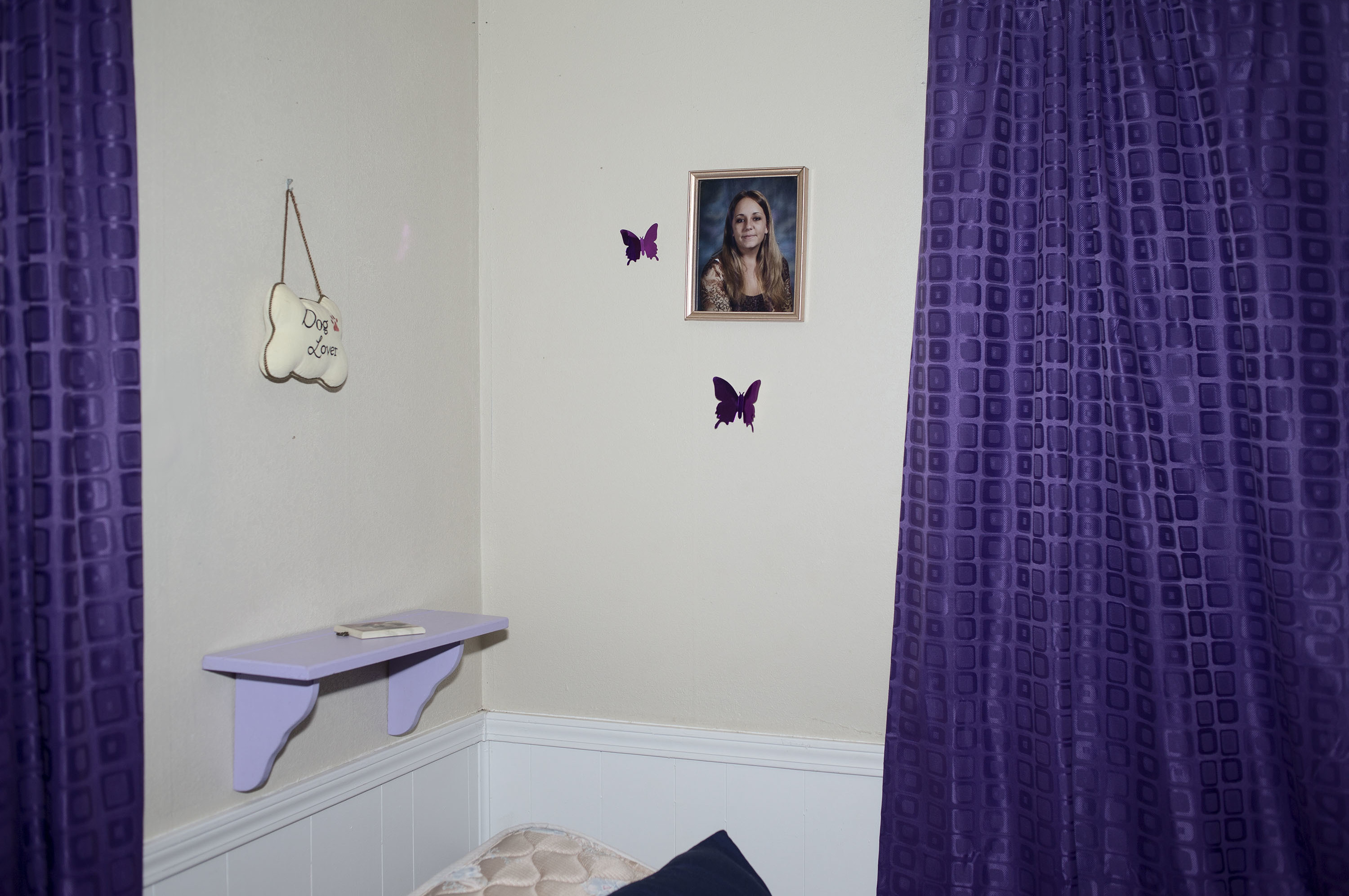 The Poetry Of Prison: A Photographer Looks At The Lives Of Oklahoma's Incarcerated 1 Crystal Kirk, 12, keeps a framed photo of her mother, Amber Kirk, above her bed in her home in Mulvane, Kan. Crystal and her two siblings have lived with their grandmother since 2011, when their mother was given a life sentence for possession and endeavoring to manufacture methamphetamine.