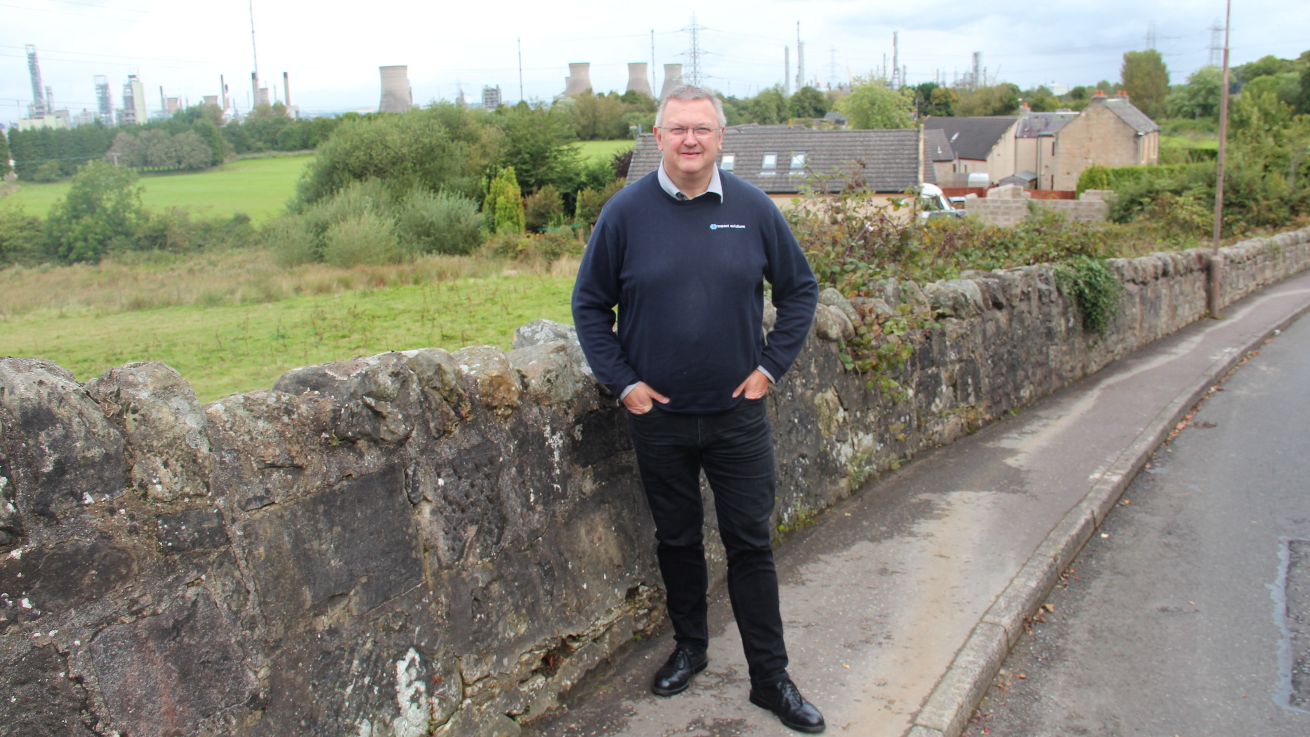Kevin Ross, president of the Scottish Plastics and Rubber Association, in front of the INEOS Grangemouth refinery and chemical plant. (The Allegheny Front)