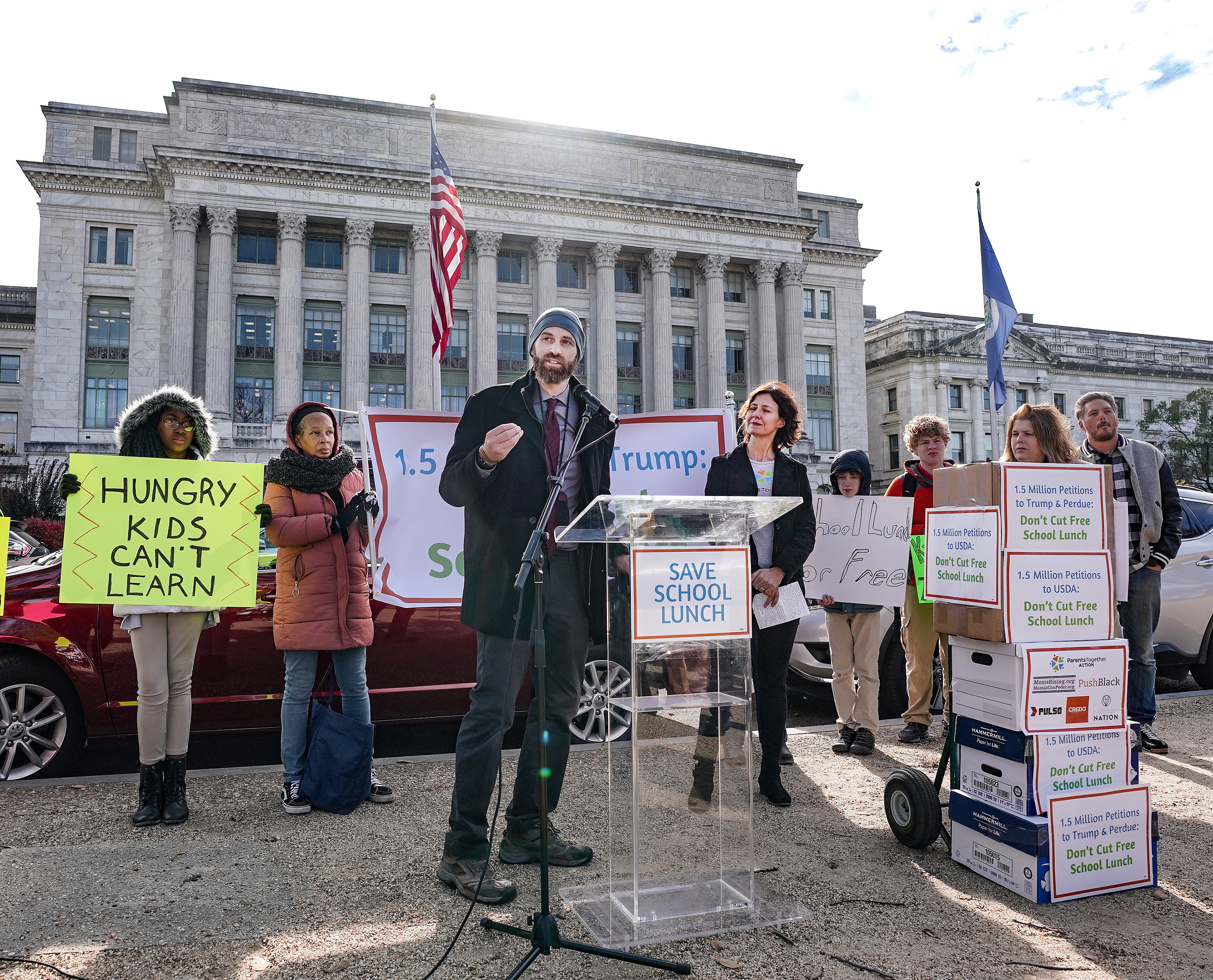Justin Ruben of ParentsTogether speaks on Thursday at a press conference organized to deliver 1.5 million petitions to the U.S. Department of Agriculture. The petitions are protesting proposed changes to the food stamps program that would also affect the free school lunch program. (Getty Images for Parents Together)