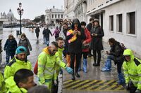 Volunteers set up a footbridge across Venice's flooded Riva degli Schiavoni embankment on Nov. 13.