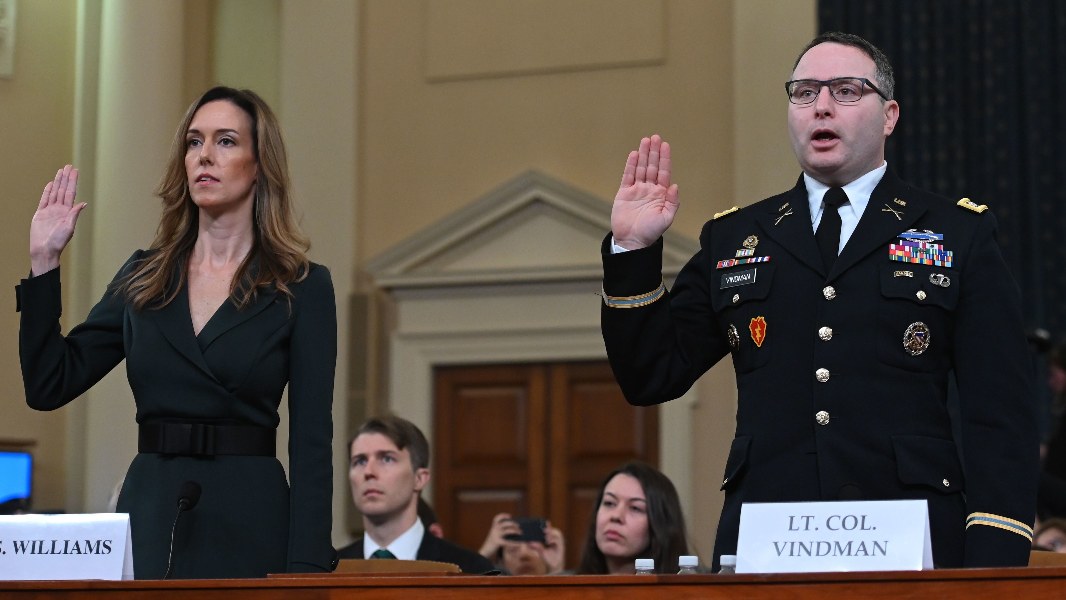 Jennifer Williams and Lt. Col. Alexander Vindman take the oath before testifying during the House Intelligence Committee hearing on Tuesday. (AFP via Getty Images)