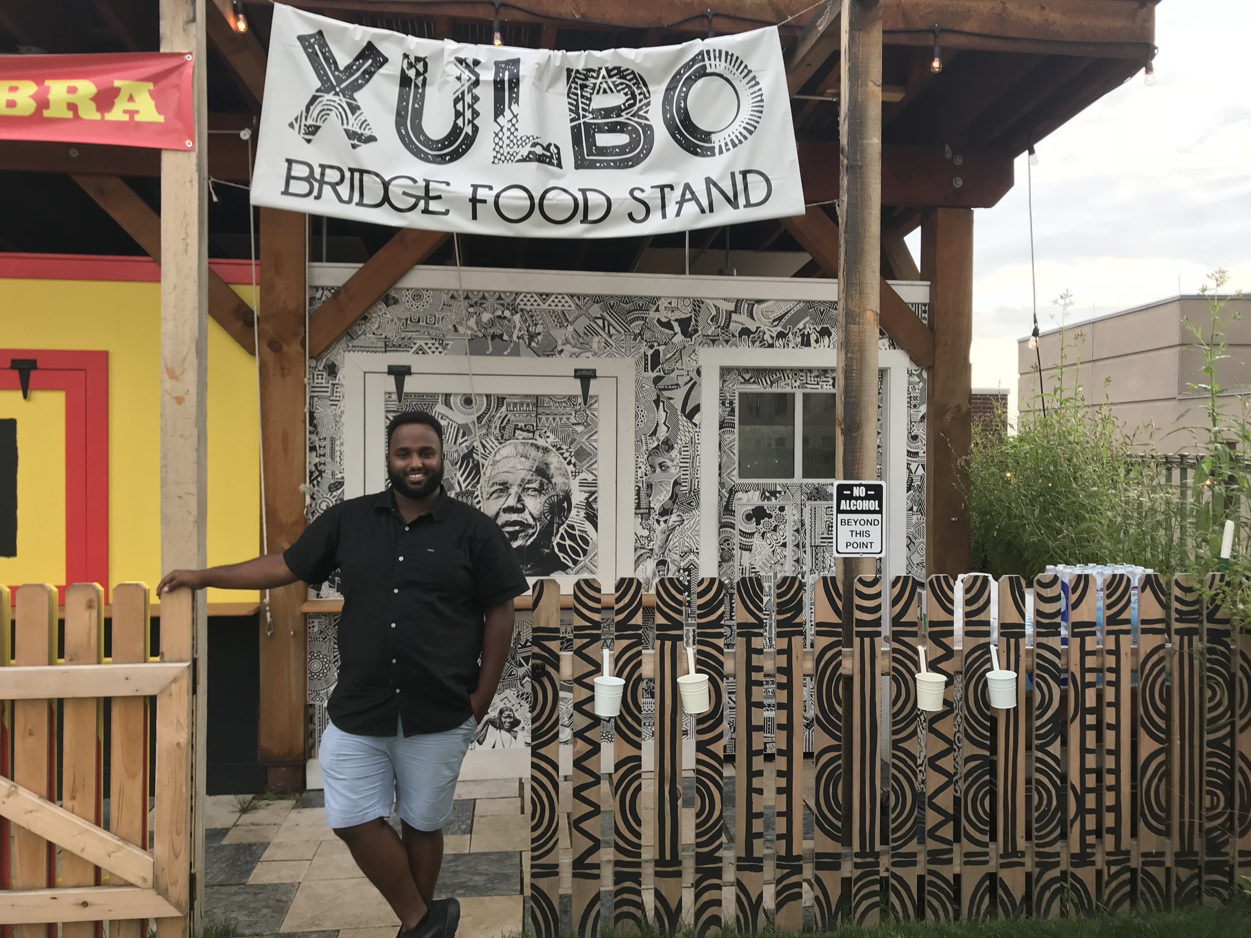 Mustafa Nuur, 27, stands outside of his family's food stand in Lancaster City, Pa. (NPR)