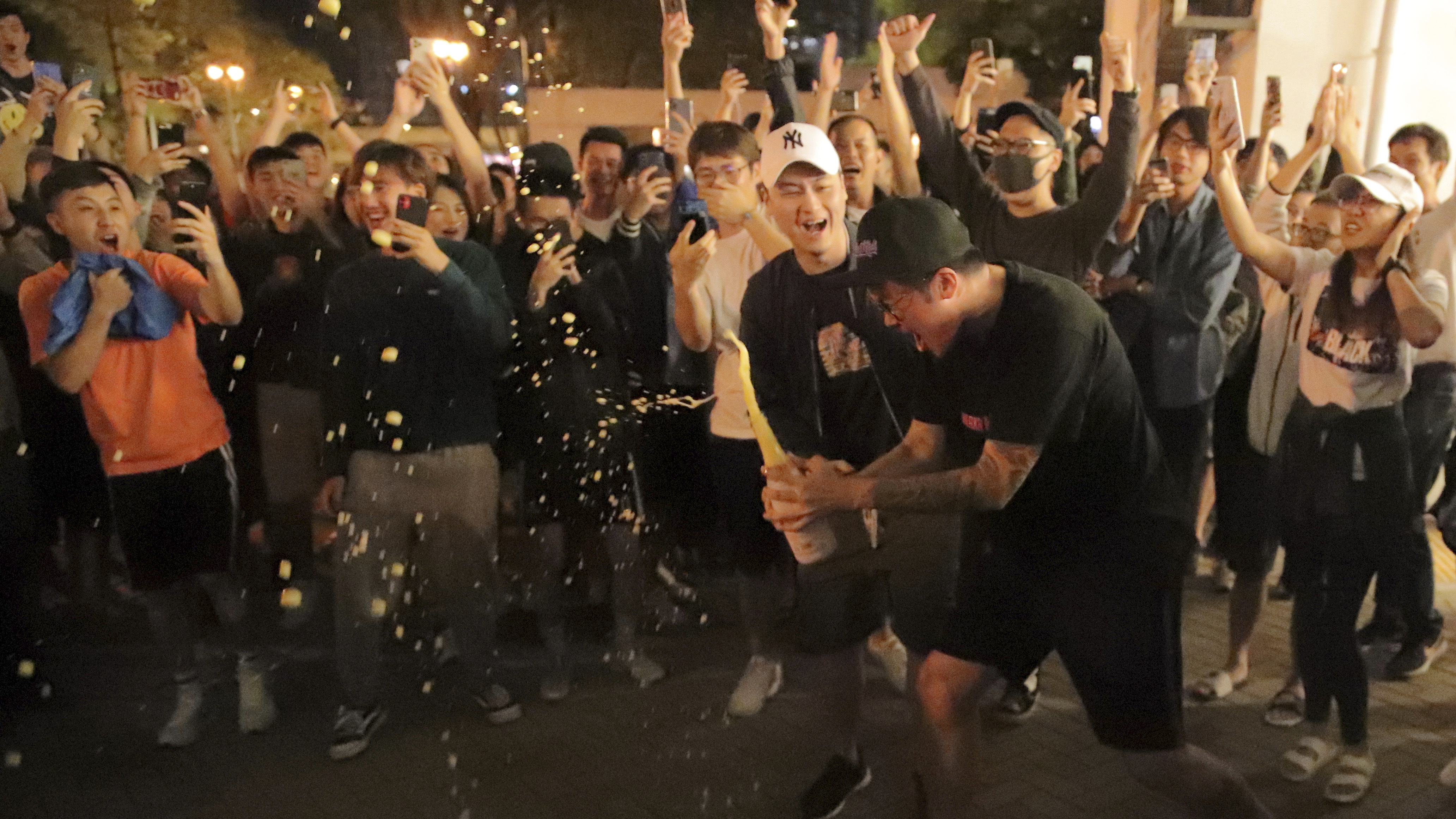 Pro-democracy supporters celebrate after pro-Beijing politician Junius Ho lost his election in Hong Kong, early Monday, Nov. 25, 2019.