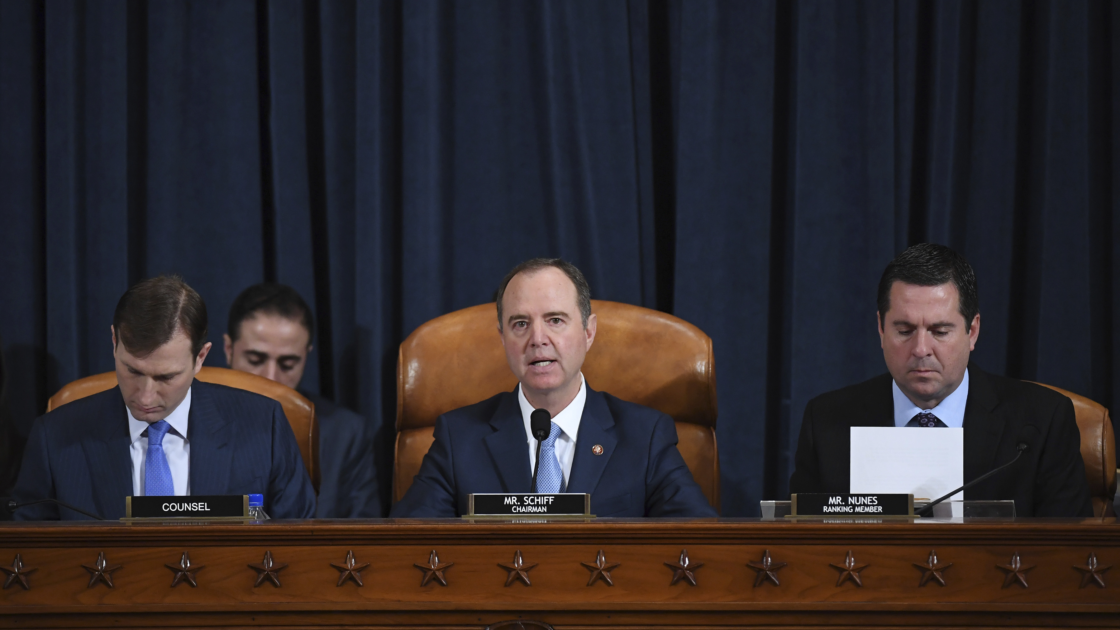 House Intelligence Committee Chairman Adam Schiff, D-Calif. (center); ranking member Rep. Devin Nunes of California (right); and committee counsel Daniel Goldman hold an impeachment inquiry hearing on Nov. 21. Schiff has released the panel's report on the inquiry. (AP)