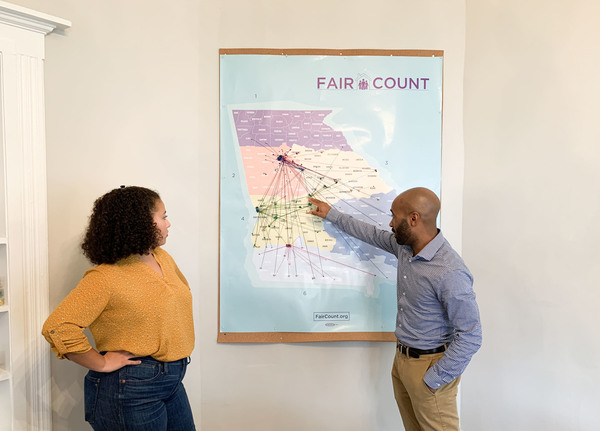 Ed Reed (right), Fair Count's program manager, and Djemanesh Aneteneh, an operations and events administrator, look over a map showing the Wi-Fi hotspots the group has installed around Georgia.