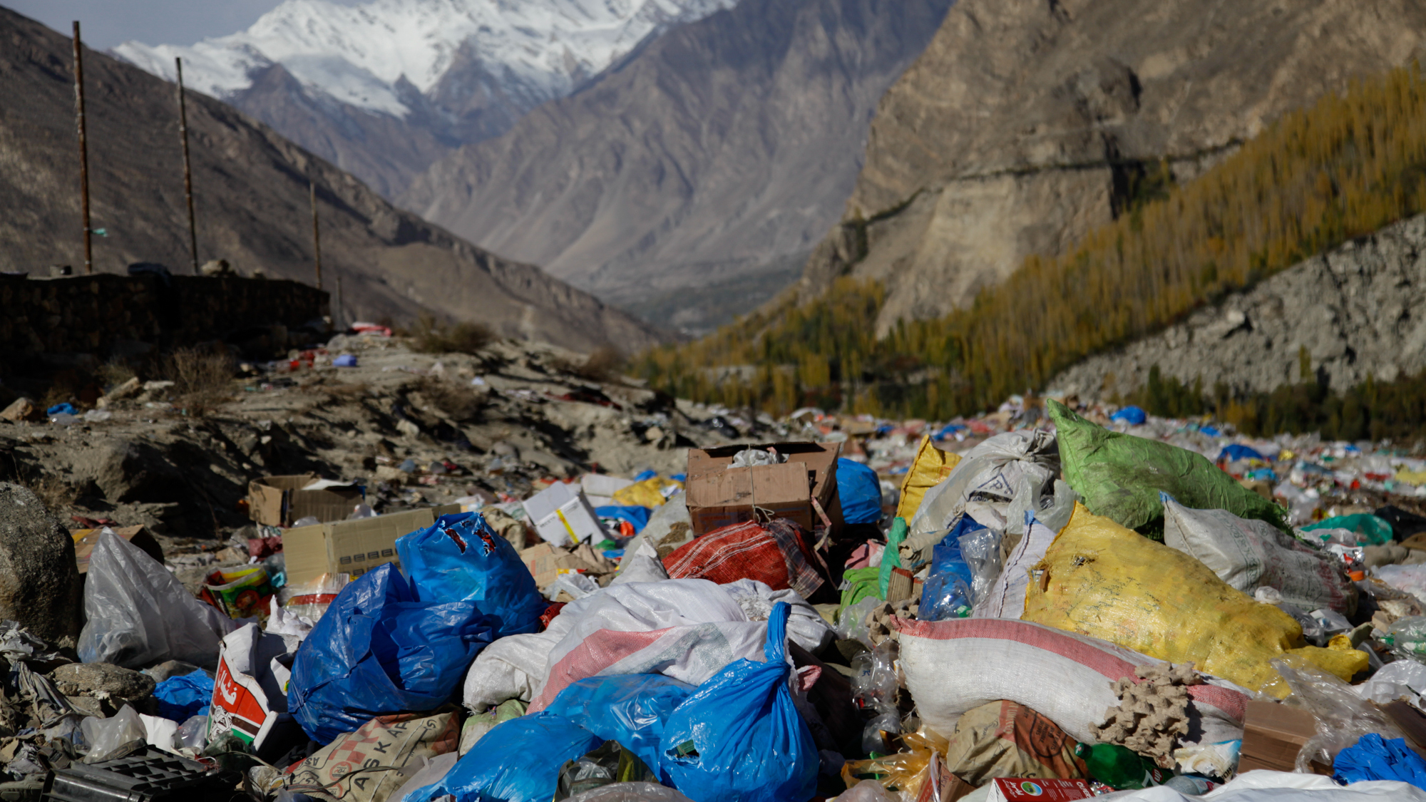 An informal dump in far northern Pakistan where residents hurl medical and tourist trash. The trash is frequently incinerated, sending up plumes of foul-smelling smoke right near a glacial lake frequented by tourists.