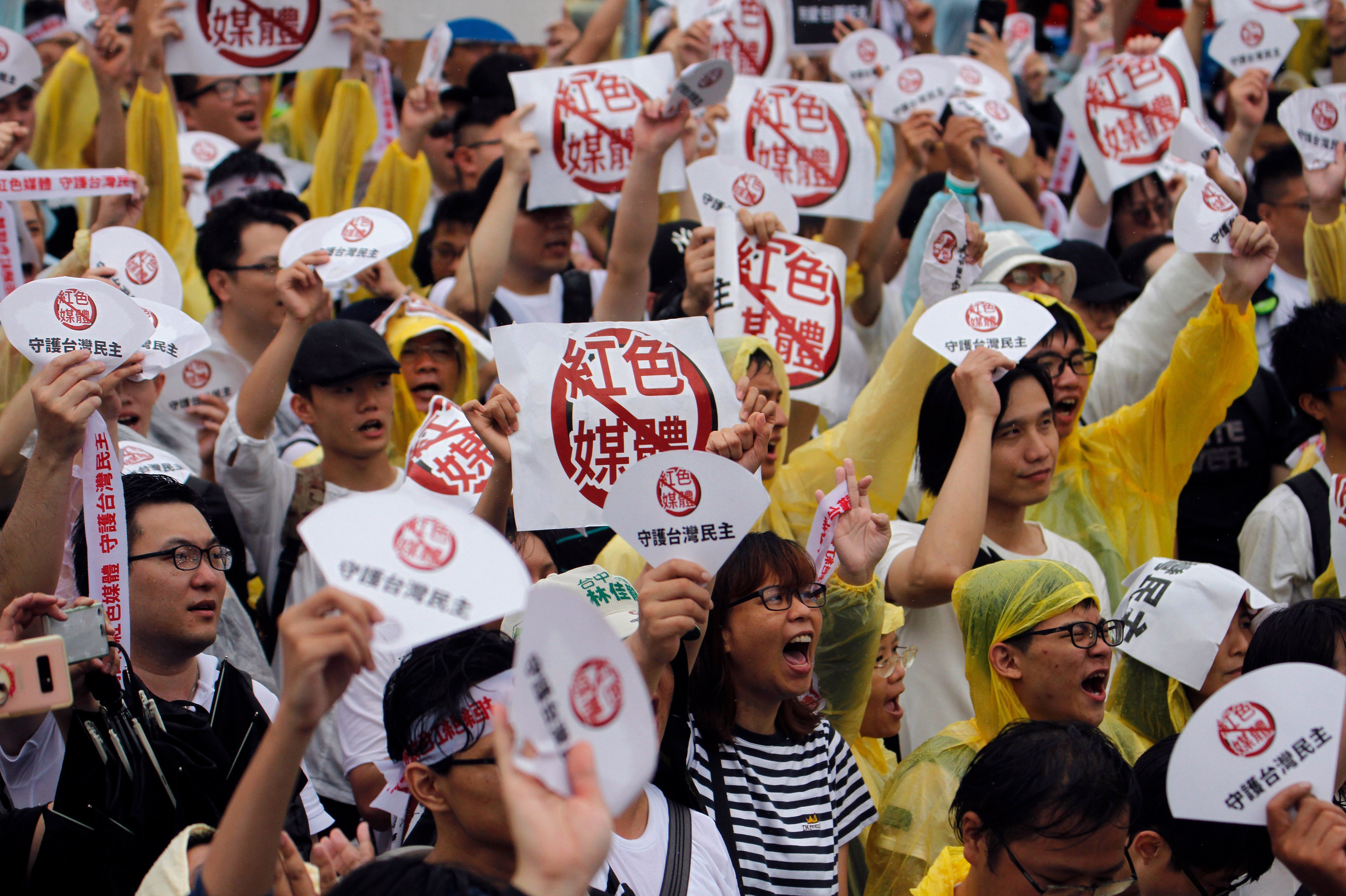Demonstrators protest against what they call &quot;red media&quot; influence in Taiwan during a rally against pro-China media in front of the president's office building in Taipei on June 23. (AFP via Getty Images)
