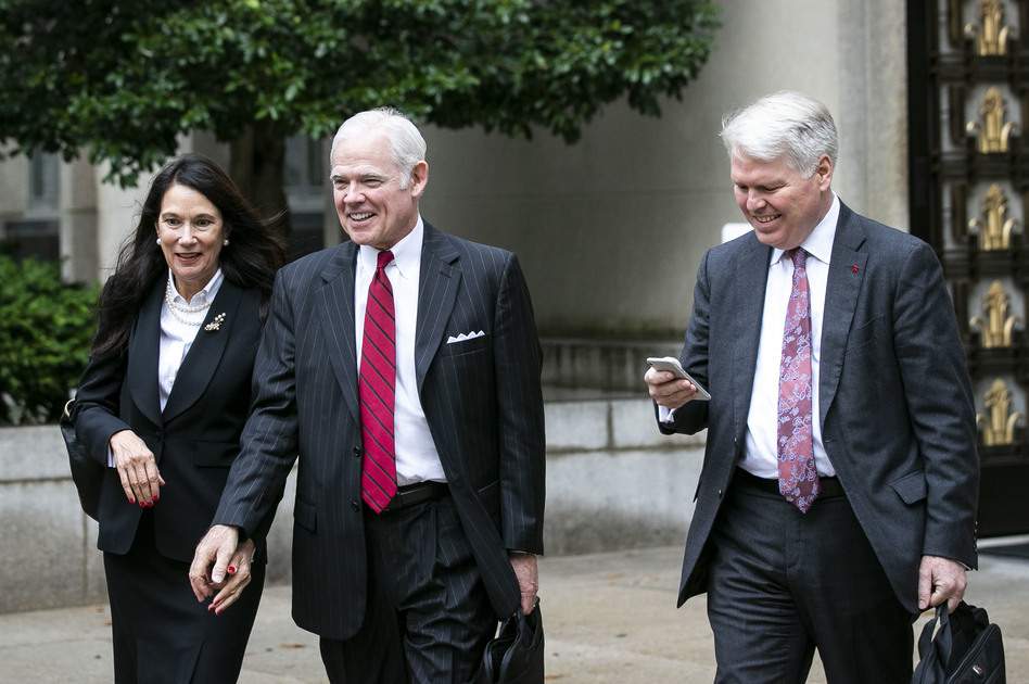 Attorney Charles Cooper, representing former national security aide Charles Kupperman (center) departs federal court in Washington in October. On Tuesday, Cooper asked a federal court to keep alive a lawsuit centered on a now-withdrawn subpoena filed by House Democrats that sought Kupperman's testimony as part of the impeachment inquiry. (Bloomberg via Getty Images)