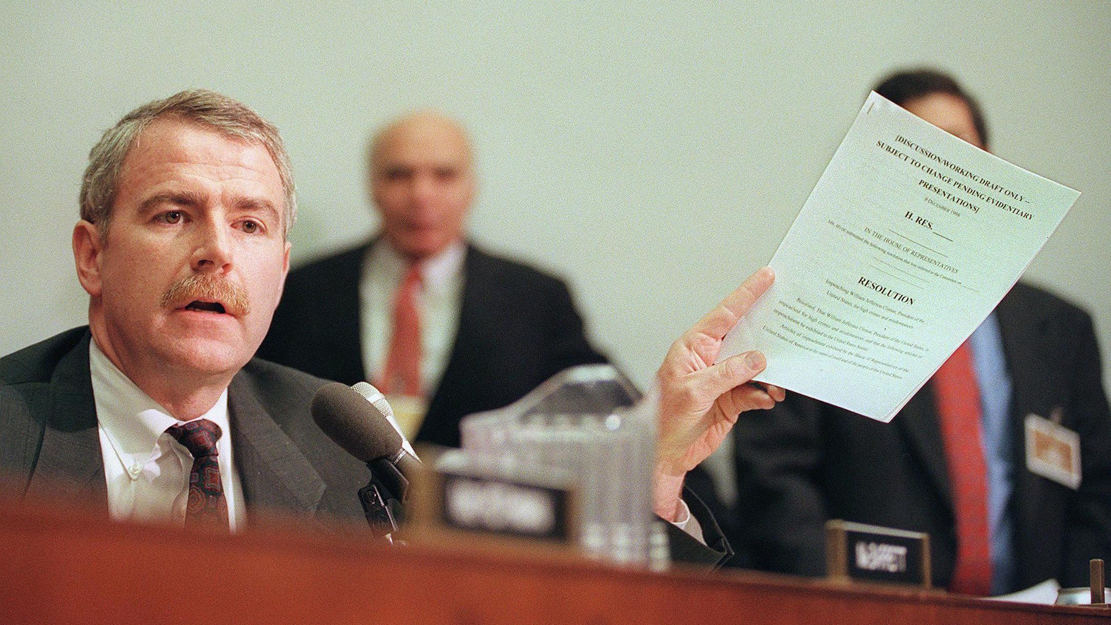 Rep. Tom Barrett, D-Wis., holds a draft copy of the Articles of Impeachment against President Clinton in December 1998. (AFP via Getty Images)