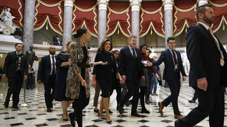 House Speaker Nancy Pelosi, D-Calif., walks to the House floor on Wednesday before the beginning of the debate over articles of impeachment. (Patrick Semansky/AP)